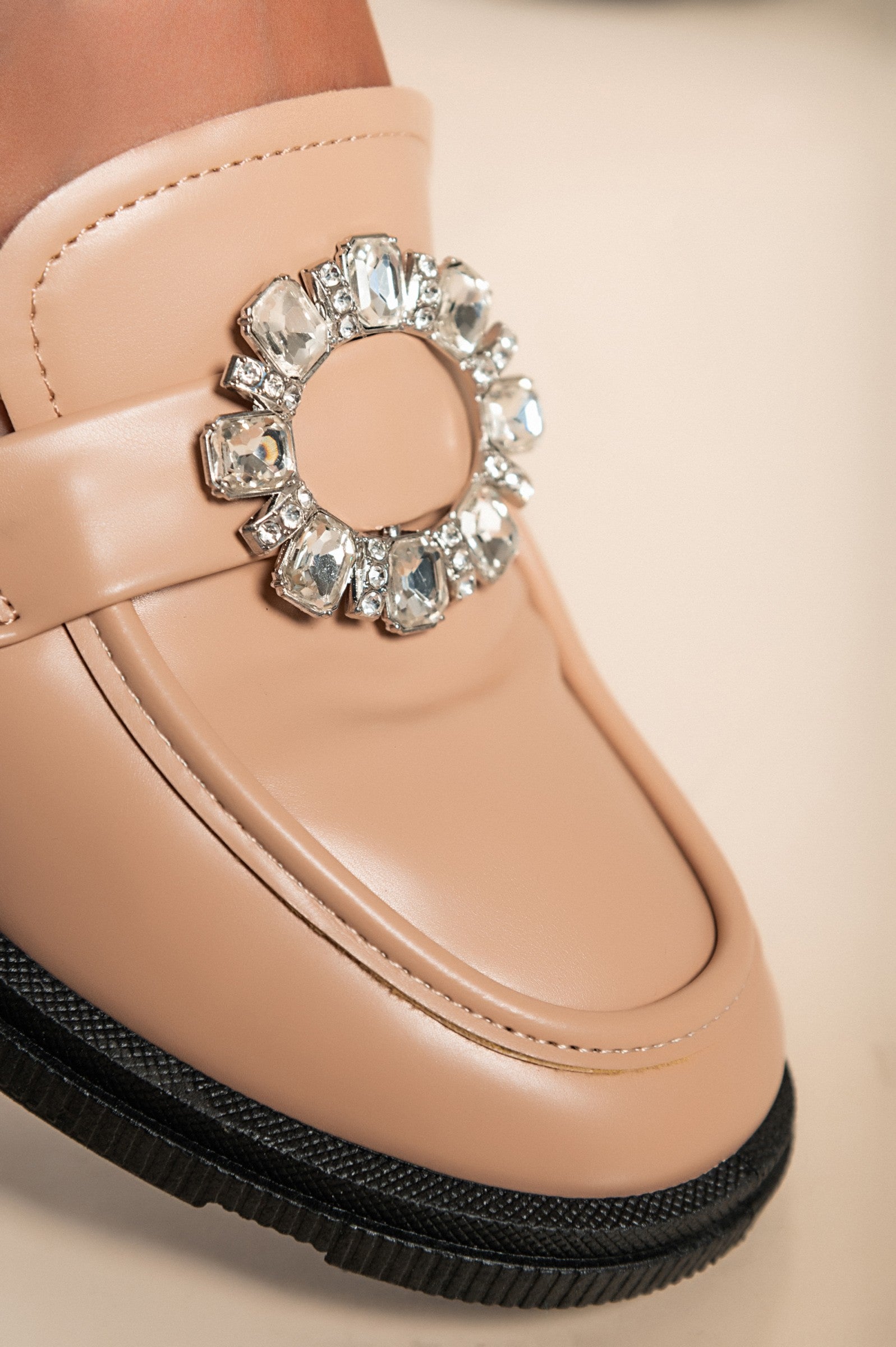 Elegant apricot moccasins with flat sole and decorative details, showcasing high-quality craftsmanship.