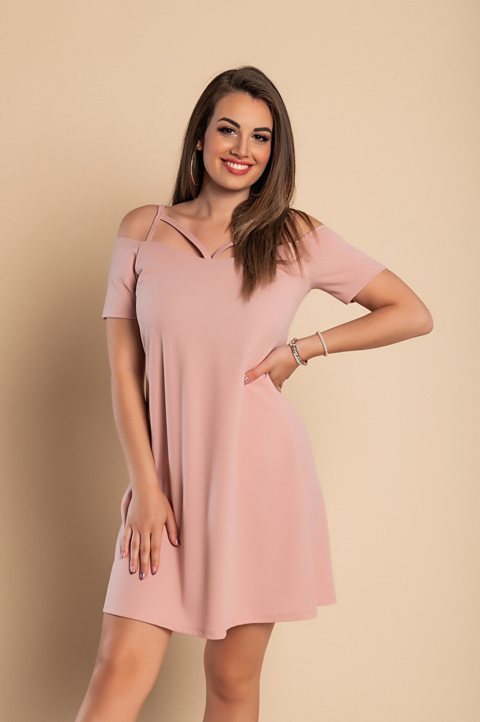 Elegant pink off shoulder strappy mini dress with short sleeves and loose skirt, perfect for casual and formal occasions.