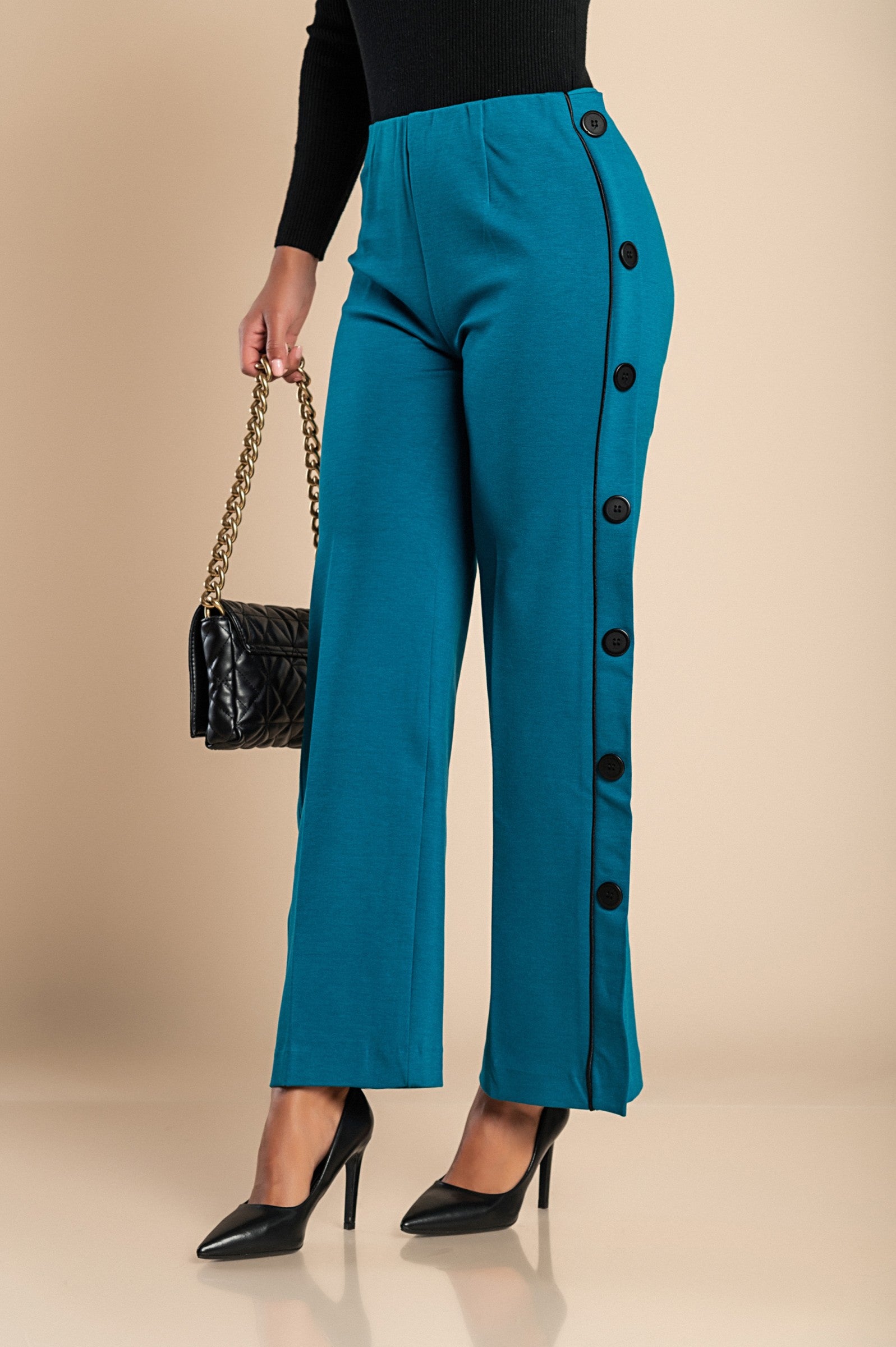 Elegant petrol pants with decorative buttons on the sides and an elasticated waist, showcasing a straight leg design.