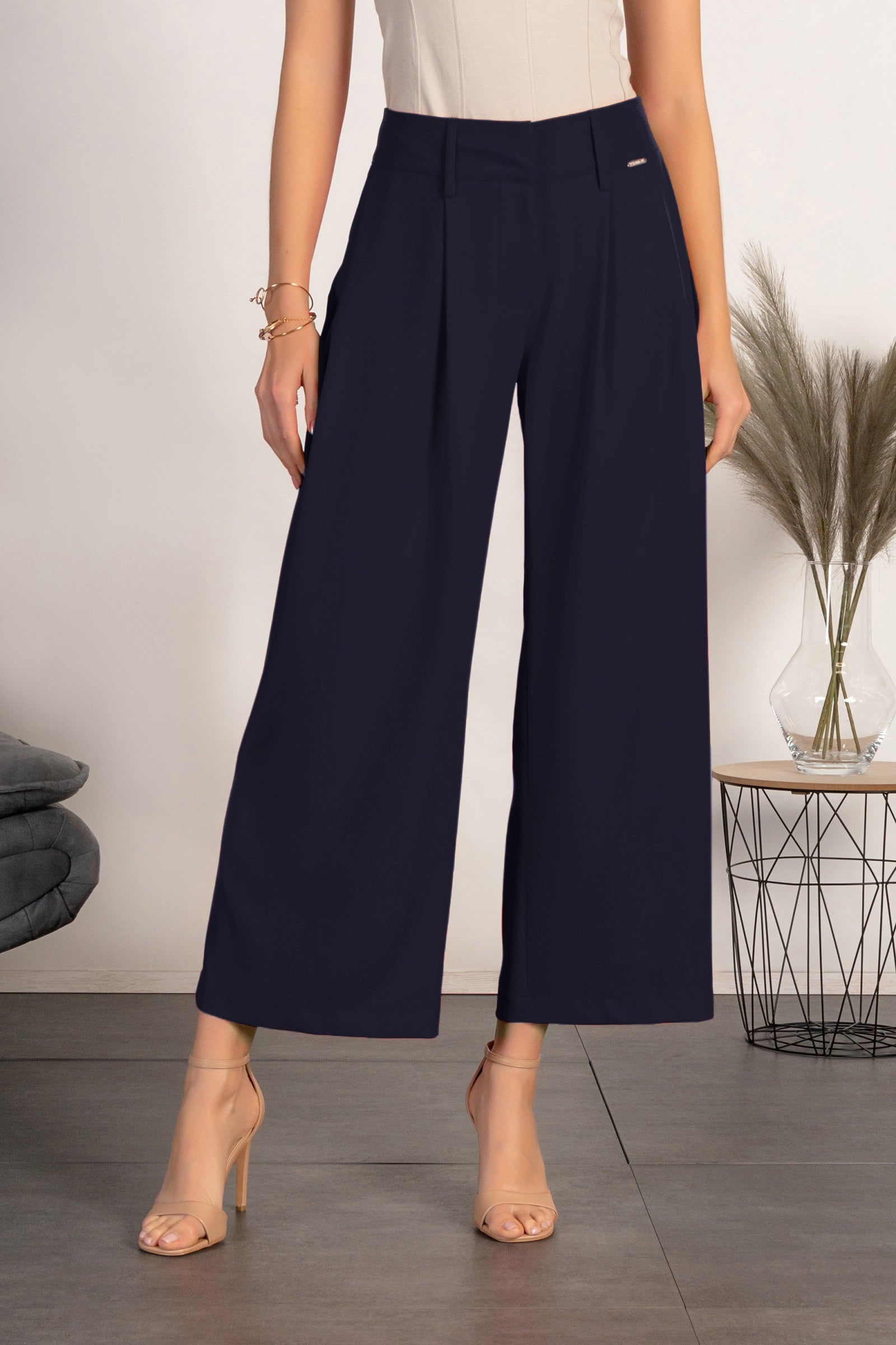 Elegant dark blue pants with loose legs, featuring a zip closure and metal hooks, made in Italy.