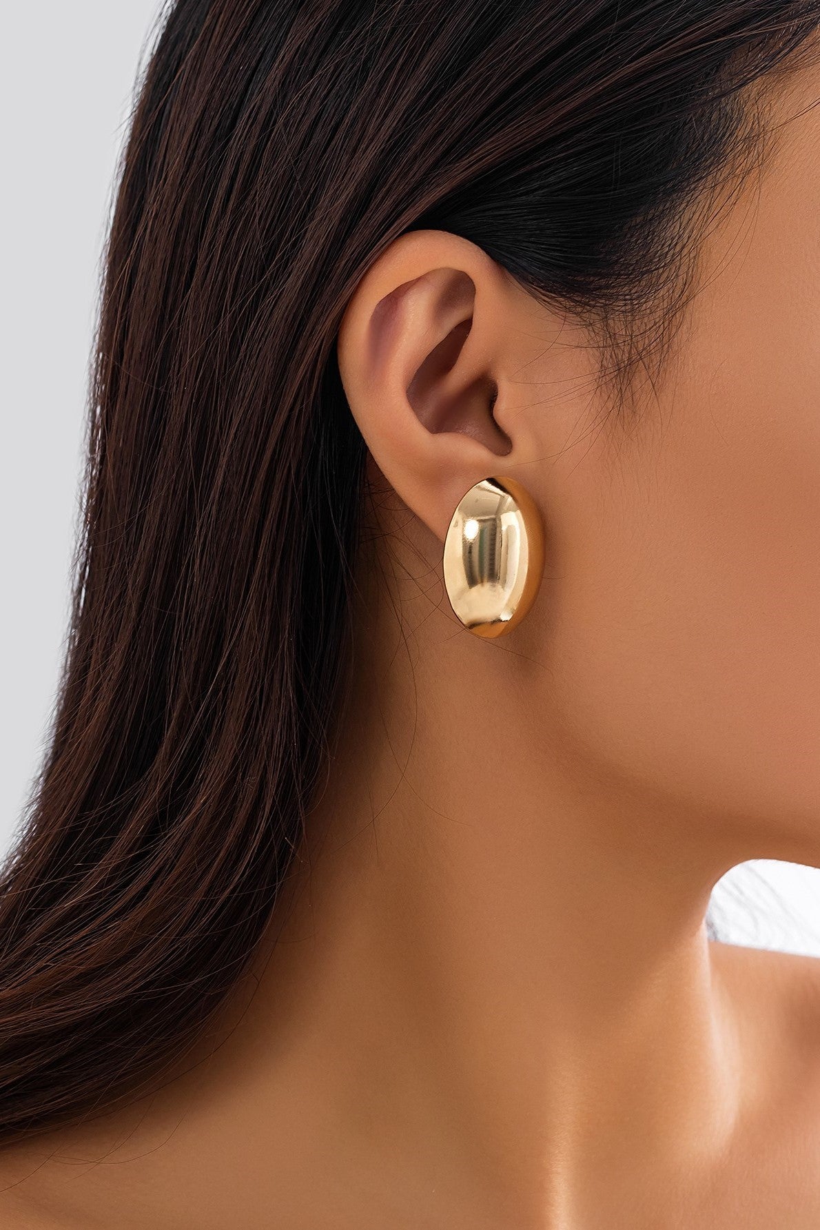 Elegant gold round earrings made from metal alloy, showcasing a stylish and sophisticated design.