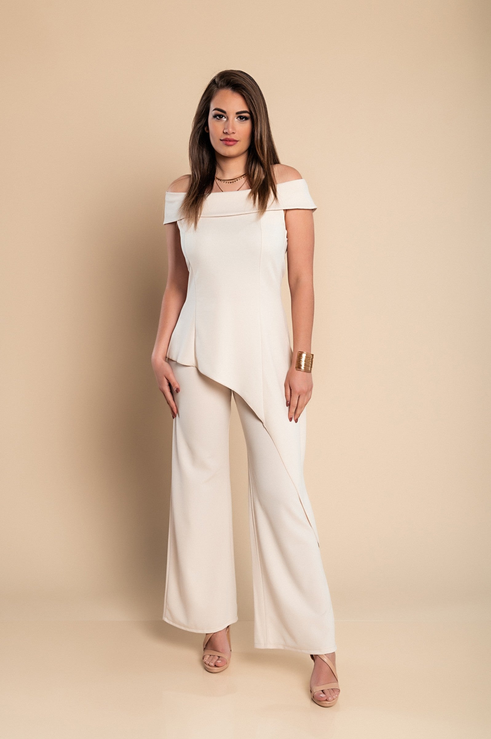 Elegant beige asymmetrical top and loose trousers set, showcasing a bateau neckline and elastic waist for comfort.