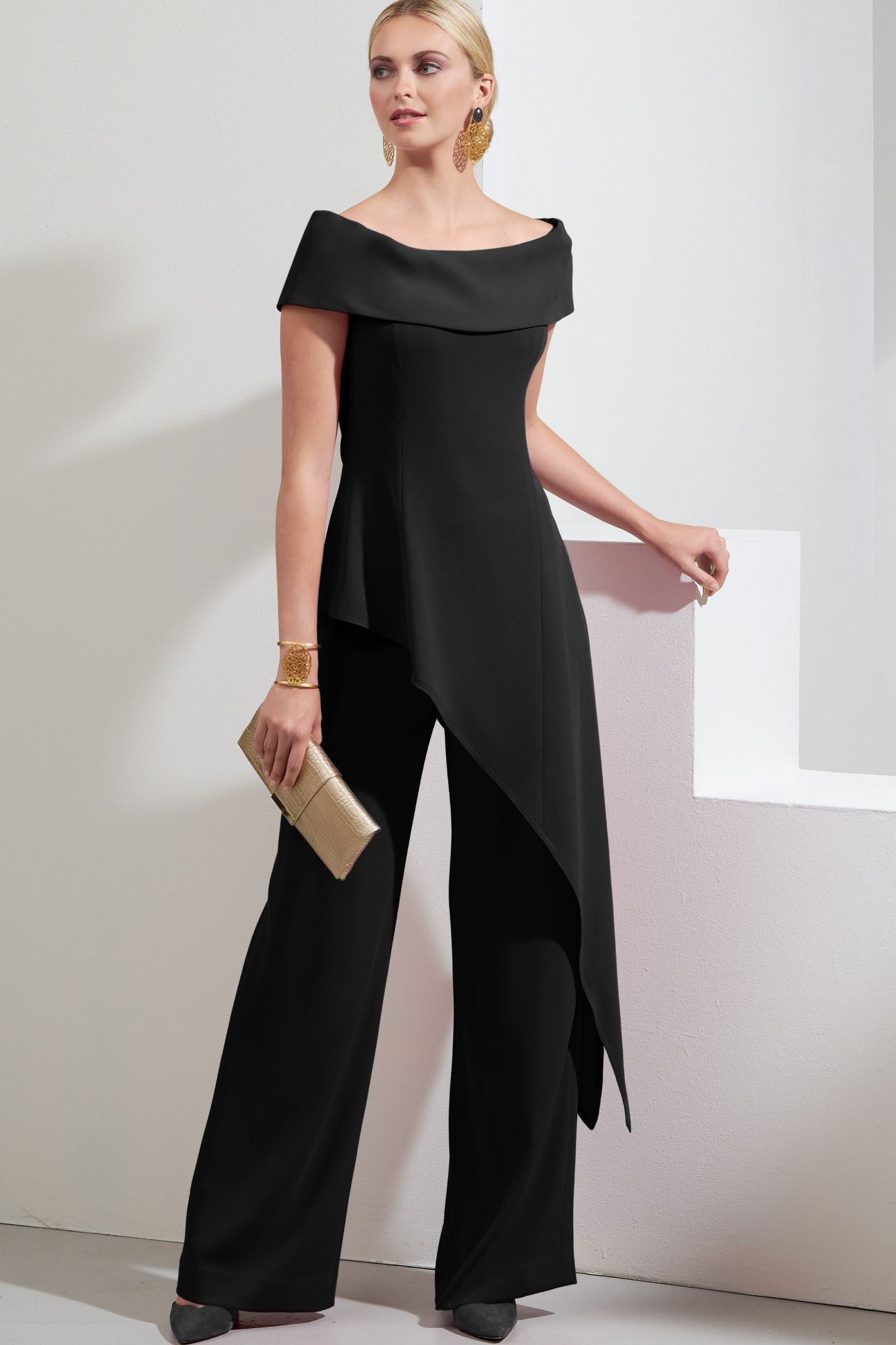 Elegant black asymmetrical top with loose trousers, showcasing a bateau neckline and short sleeves.