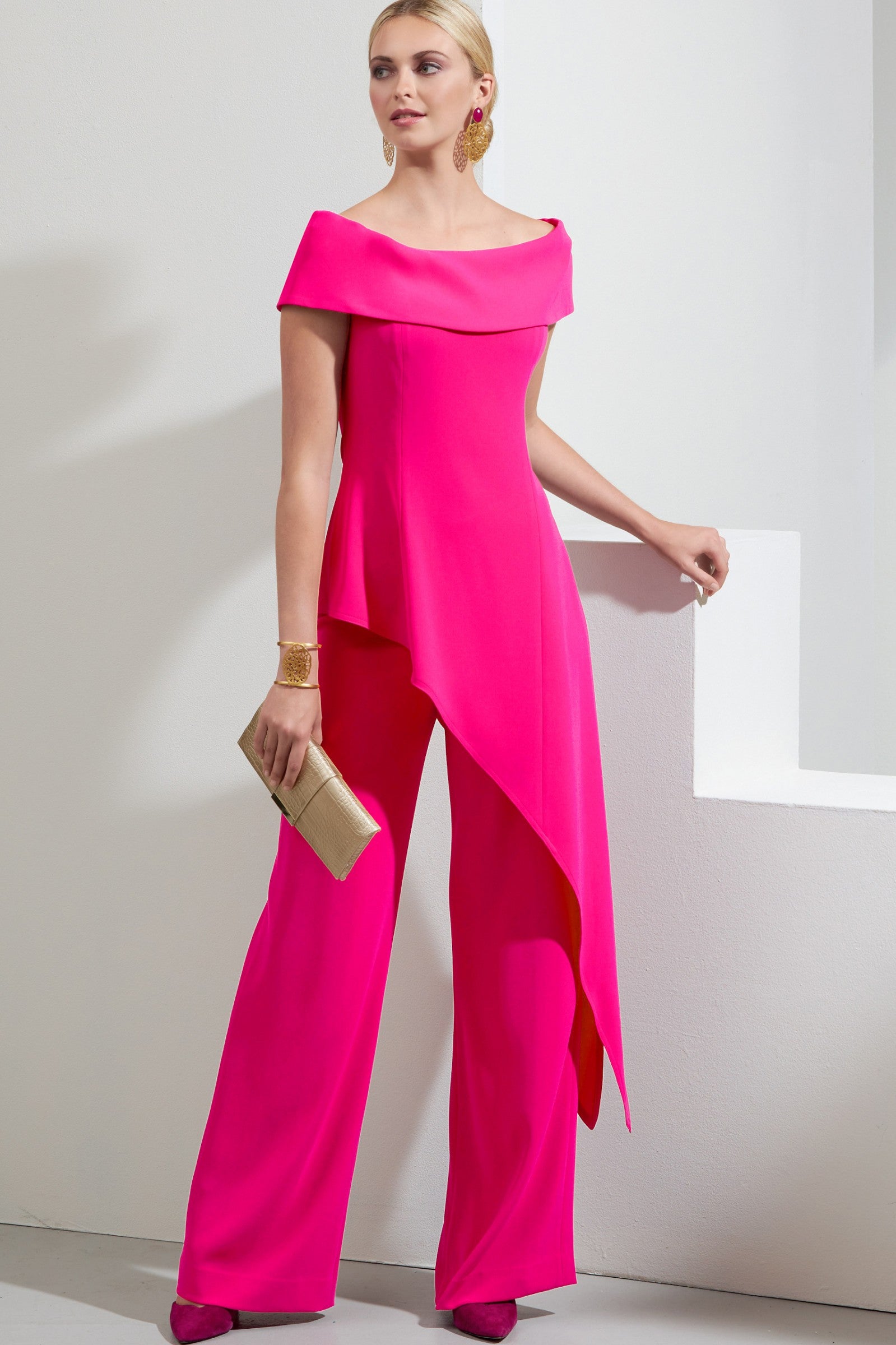 Elegant fuchsia asymmetrical top with short sleeves and loose long pants, showcasing Italian craftsmanship and quality fabric.