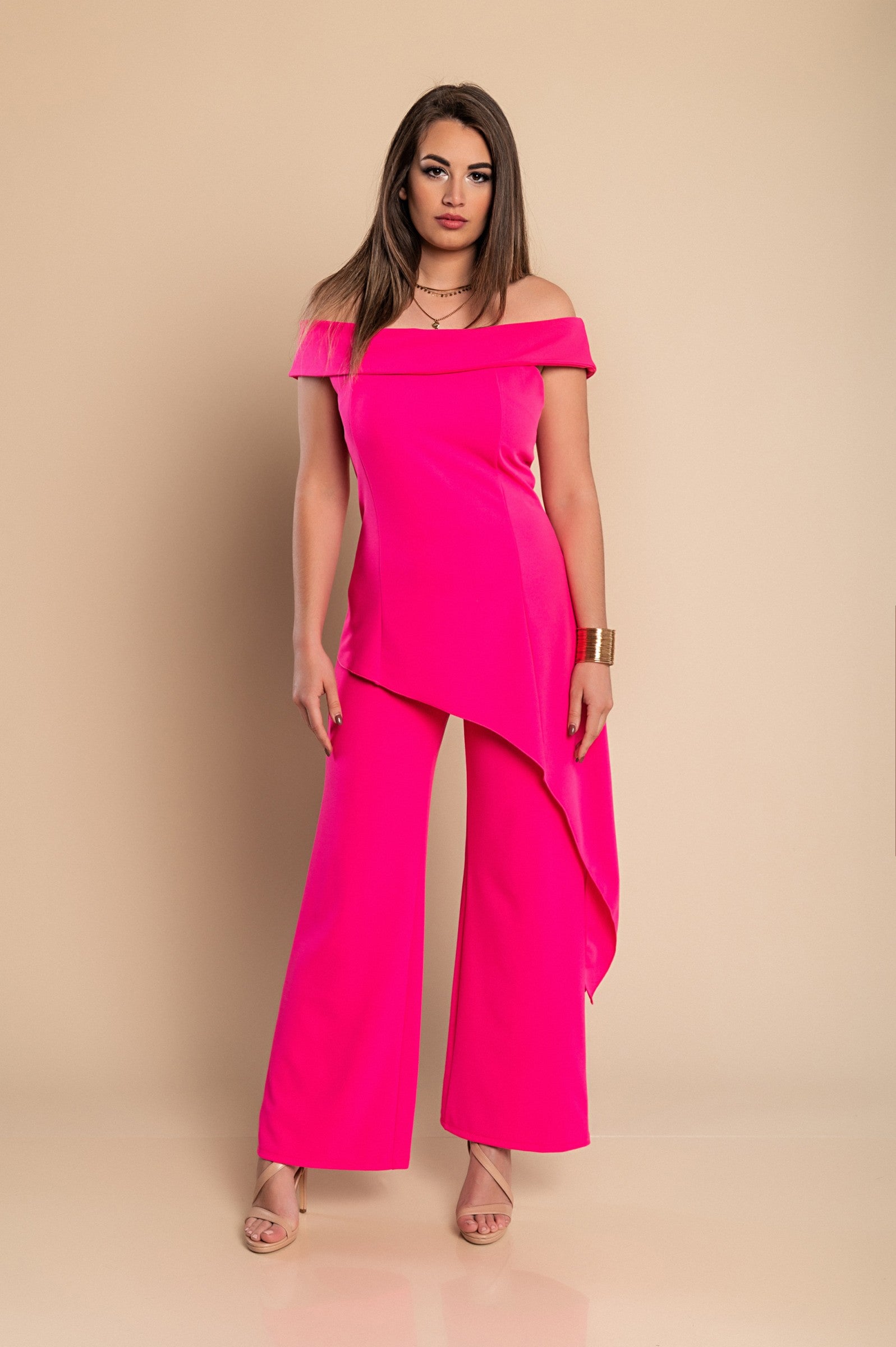 Elegant fuchsia asymmetrical top with short sleeves and loose long pants, showcasing Italian craftsmanship and quality fabric.