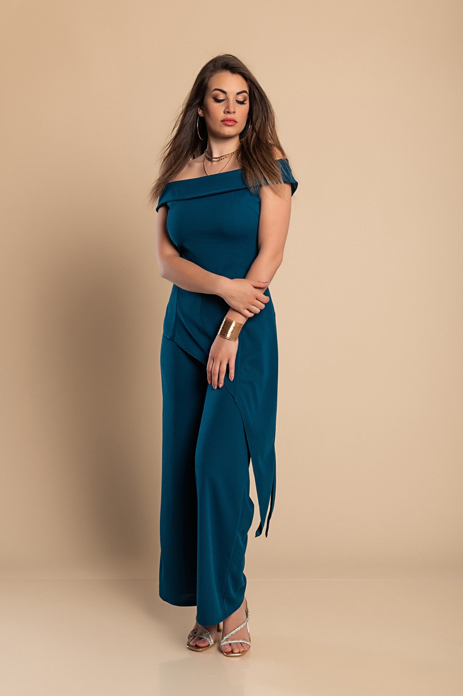 Elegant asymmetrical top and loose trousers set in petrol color, showcasing a bateau neckline and elastic waist.