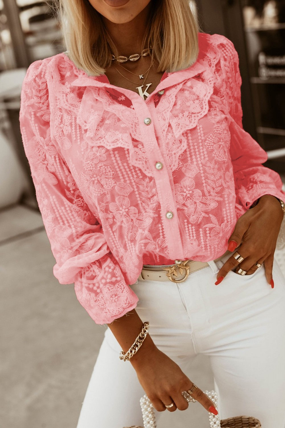 Elegant pink shirt with embroidery and frills, featuring long sleeves and a button closure, perfect for stylish outfits.