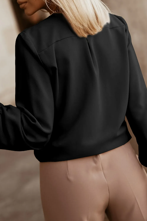 Elegant black shirt with round neck and long sleeves, featuring elastic cuffs and front button closure.