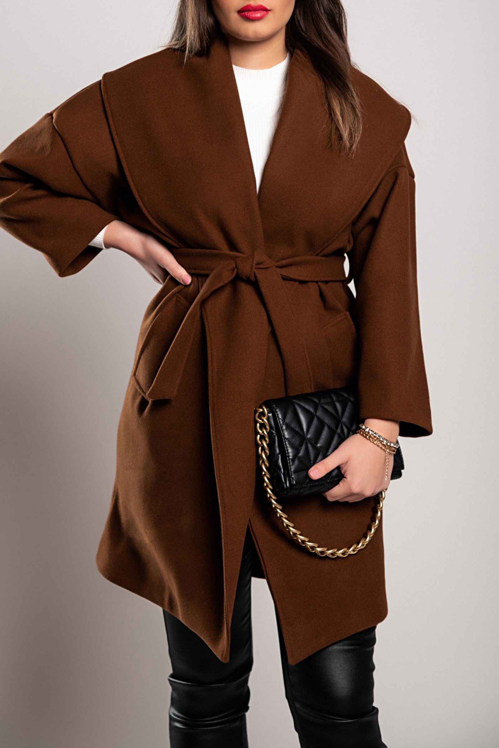 Elegant brown short coat with wide lapel collar and decorative belt, showcasing high-quality fabric and stylish design.