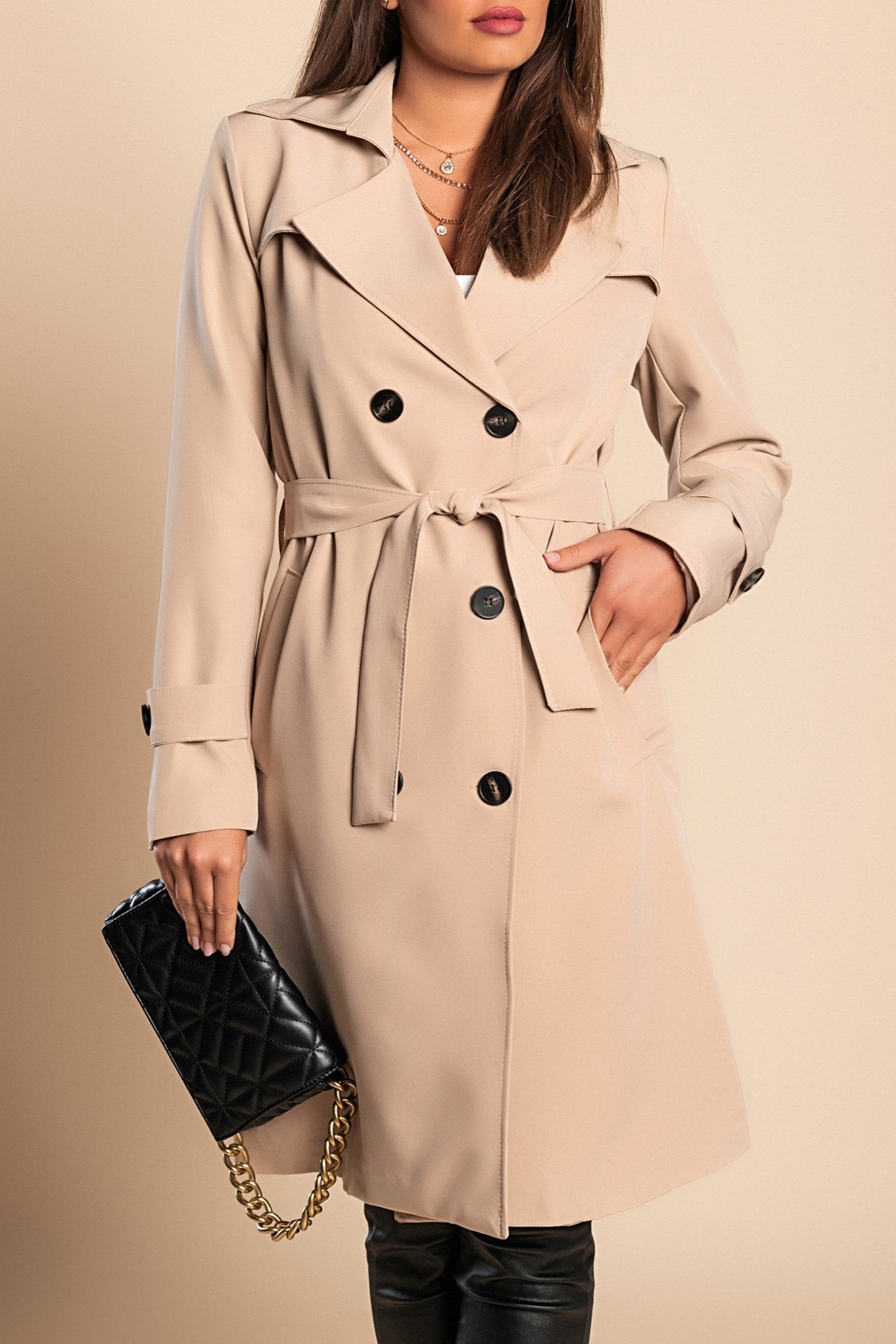 Elegant beige trench coat with buttons, featuring a classic collar and knee-length design, made in Italy.