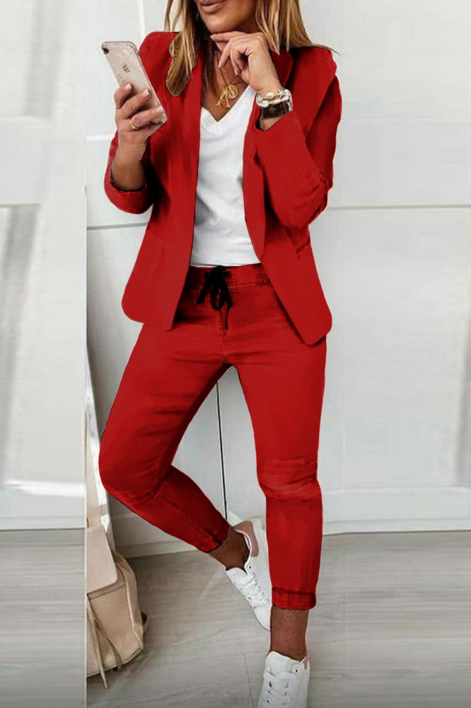 Elegant red trousers and blazer set Estrena, showcasing a stylish long-sleeve blazer and slim-fit trousers with a drawstring waist.