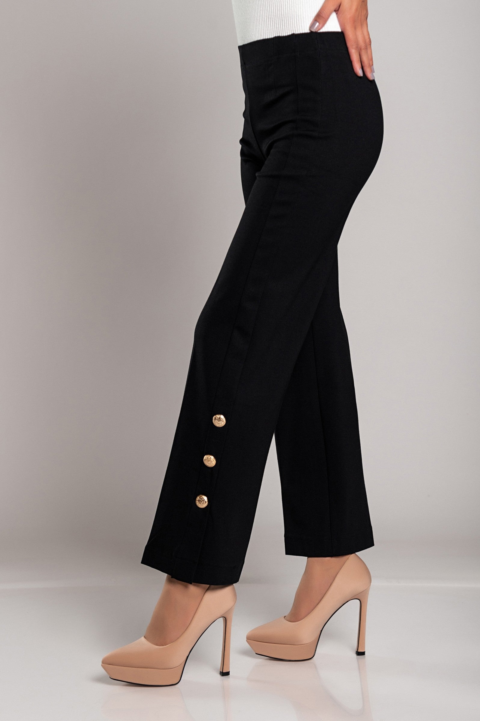 Elegant black trousers with decorative buttons and elasticated waist, showcasing a stylish design.