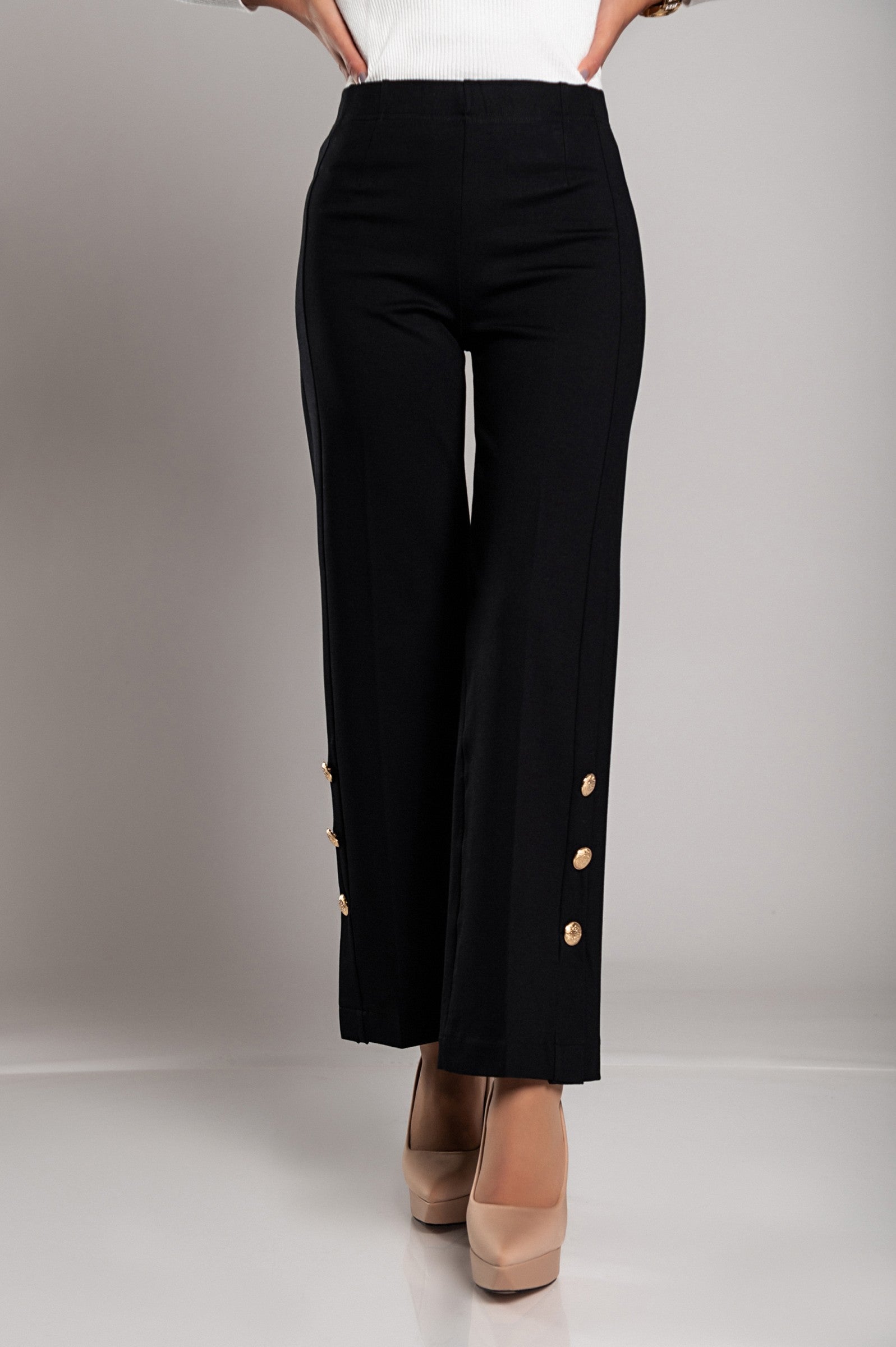 Elegant black trousers featuring decorative buttons and an elasticated waist, designed for comfort and style.