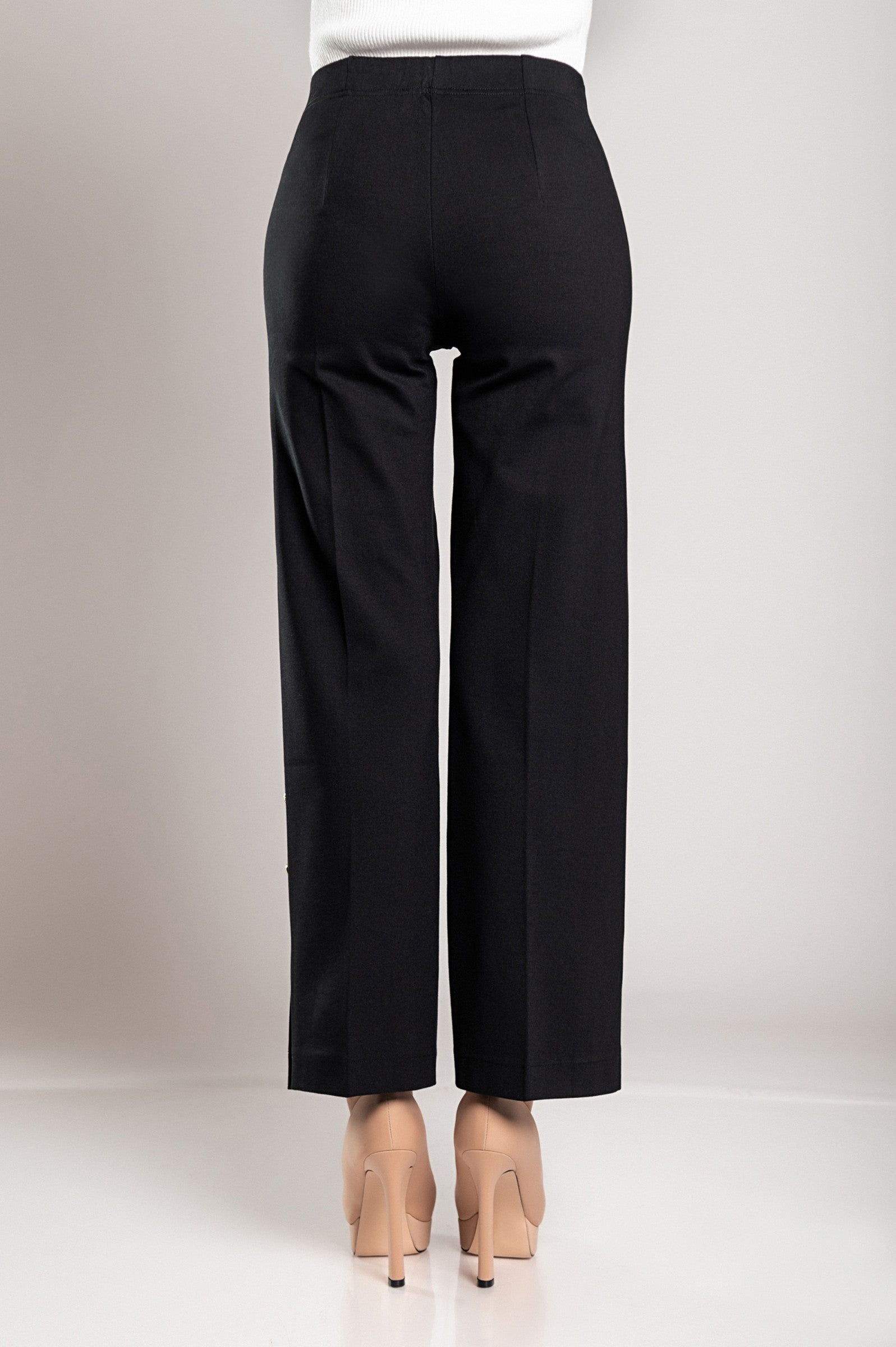 Elegant black trousers featuring decorative buttons and an elasticated waist, designed for comfort and style.