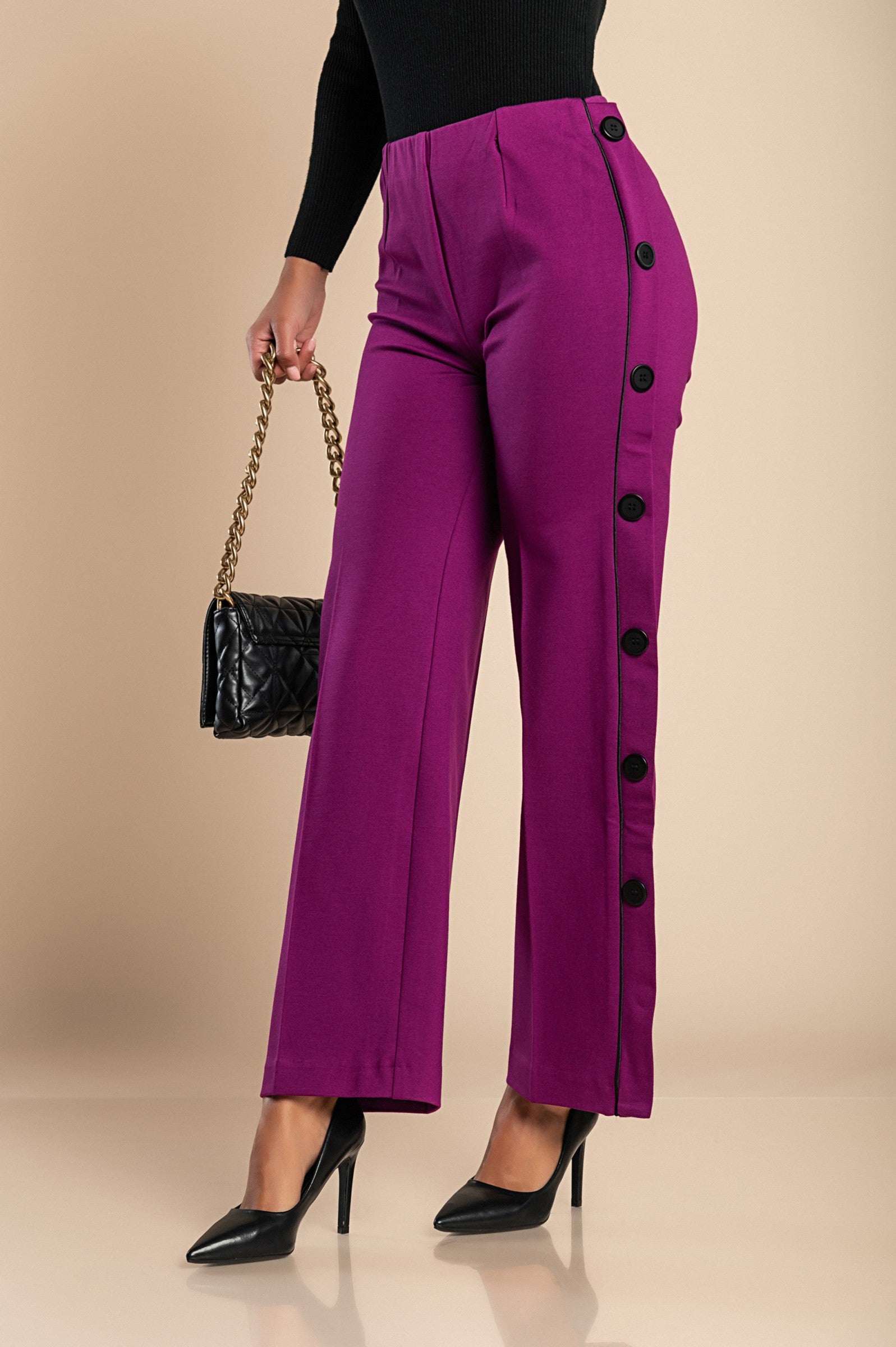 Elegant fuchsia trousers with decorative buttons on the sides and an elasticated waist, showcasing a straight leg design.