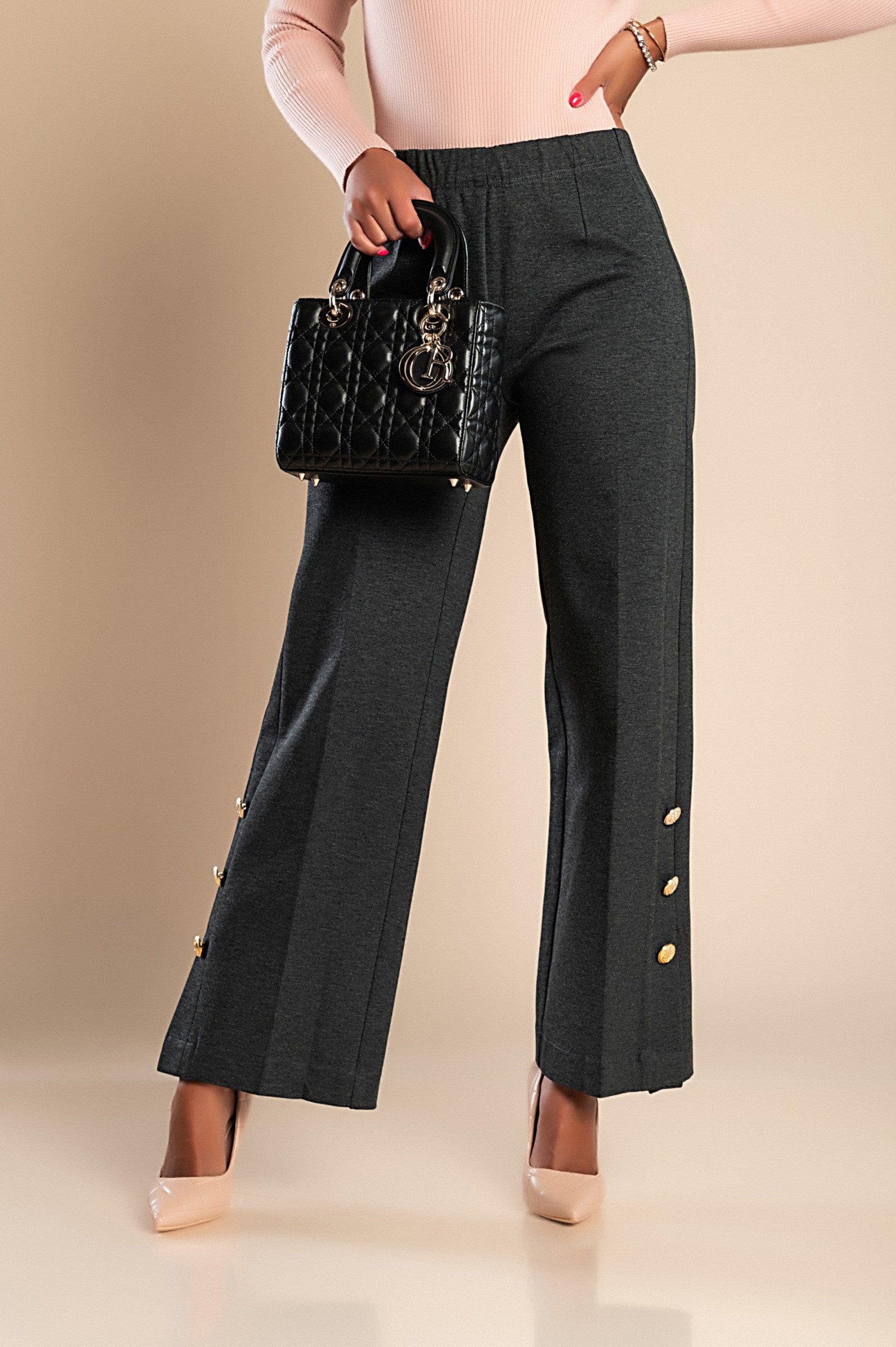 Elegant grey trousers with decorative buttons and elasticated waist, showcasing a stylish and comfortable design.