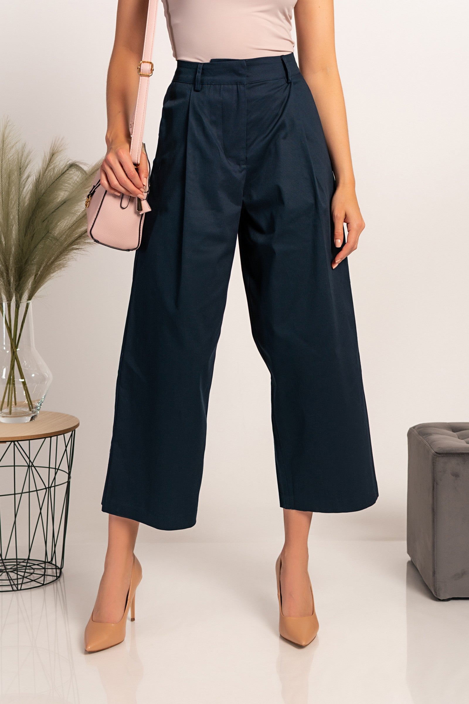 Elegant dark blue wide-leg trousers with zip closure and metal hook, made from high-quality cotton, designed for comfort and style.