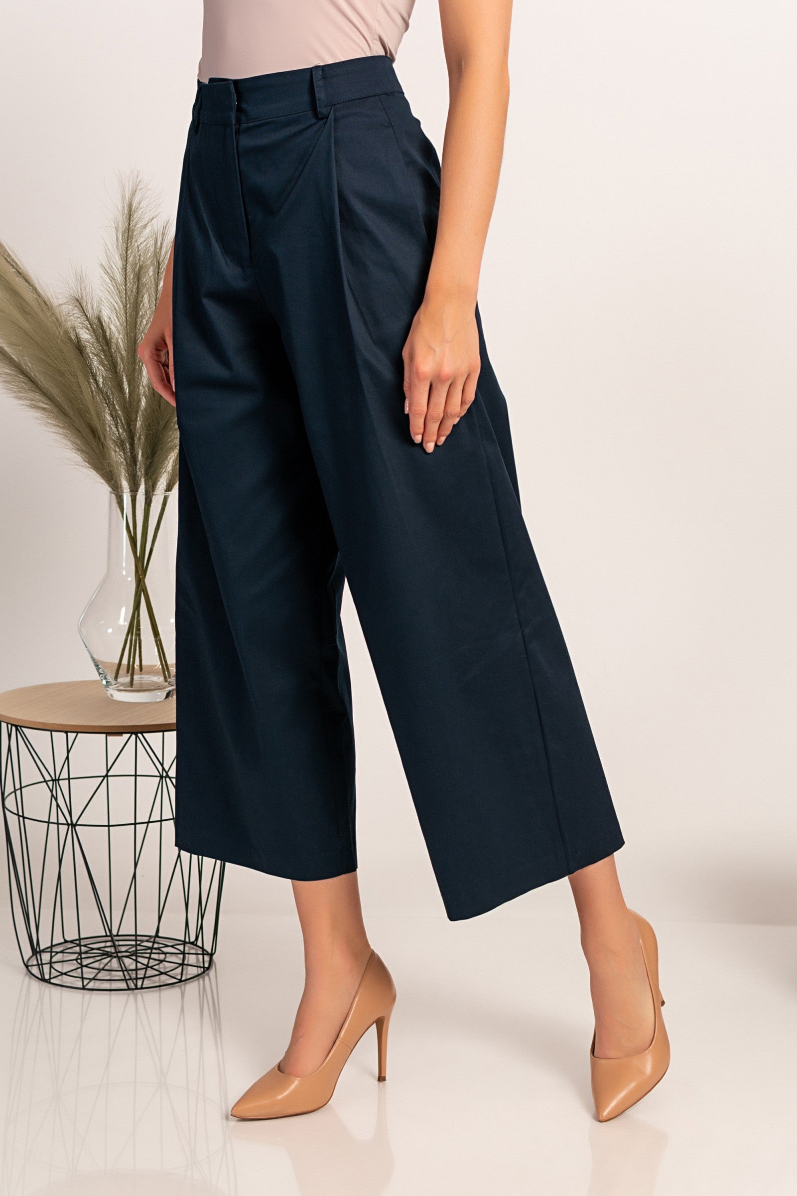 Elegant dark blue wide-leg trousers with zip closure and metal hook, made from high-quality cotton, designed for comfort and style.