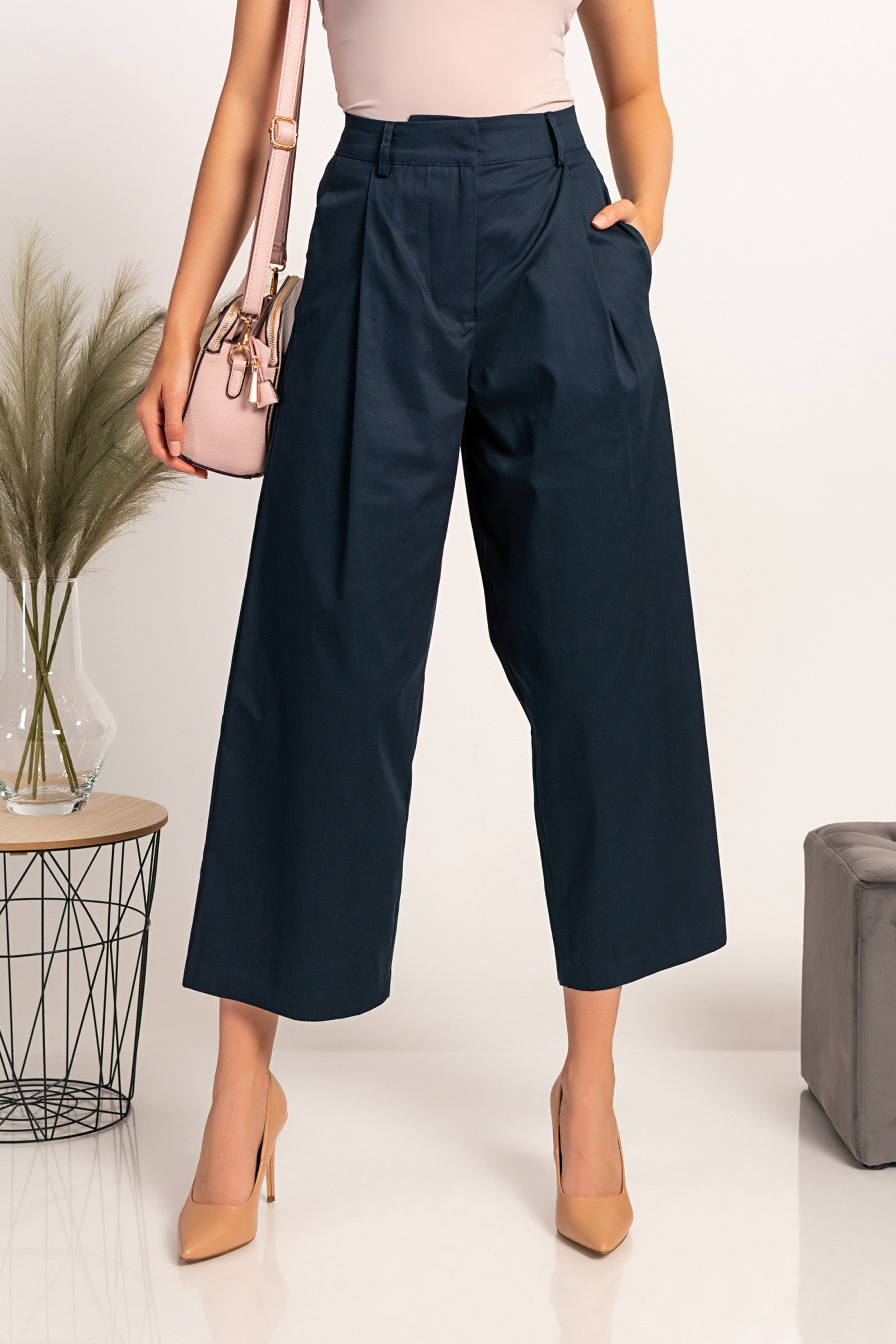 Elegant dark blue wide-leg trousers with zip closure and metal hook, made from high-quality cotton, designed for comfort and style.