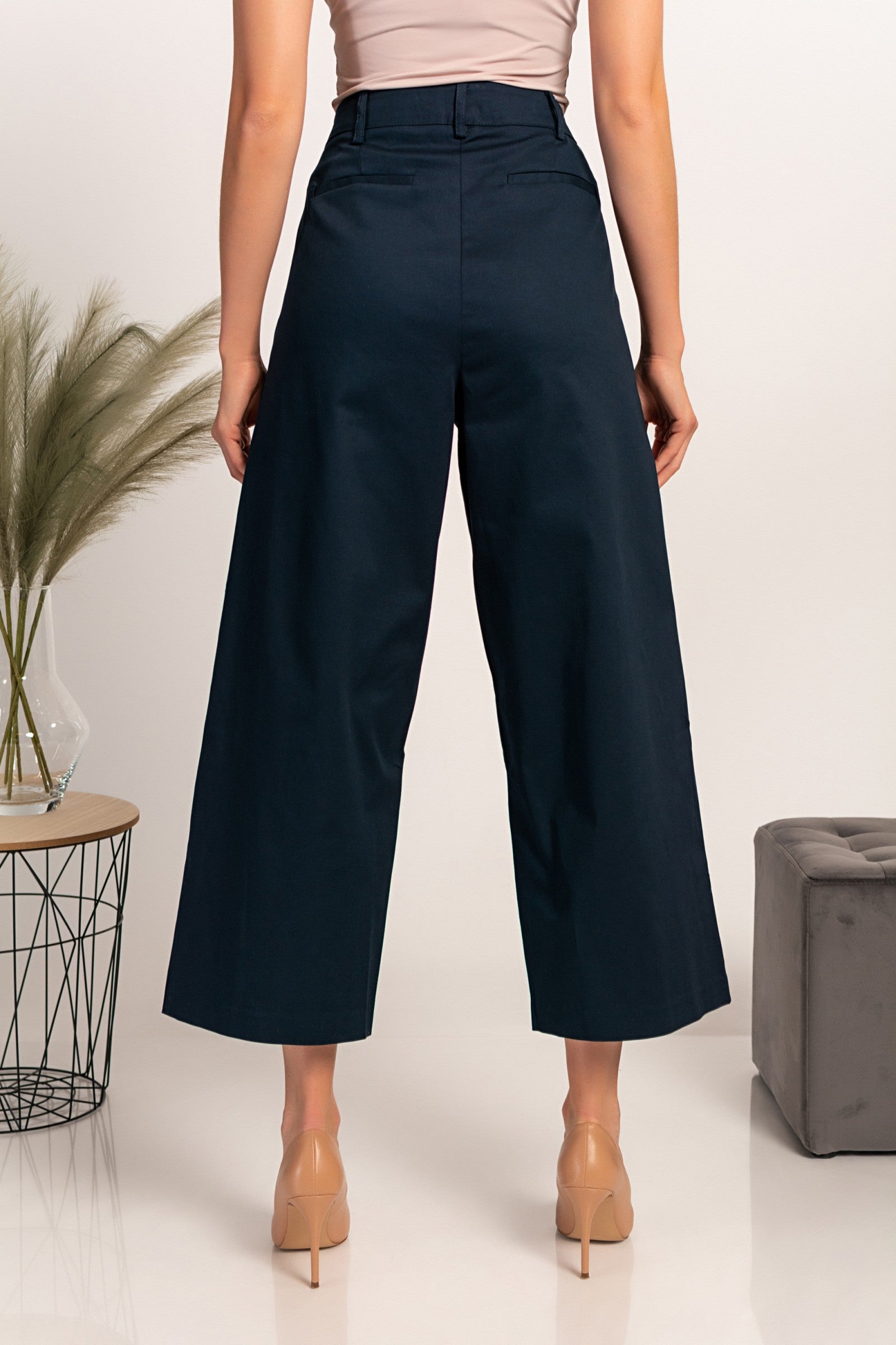 Elegant dark blue wide-leg trousers with zip closure and metal hook, made from high-quality cotton, designed for comfort and style.