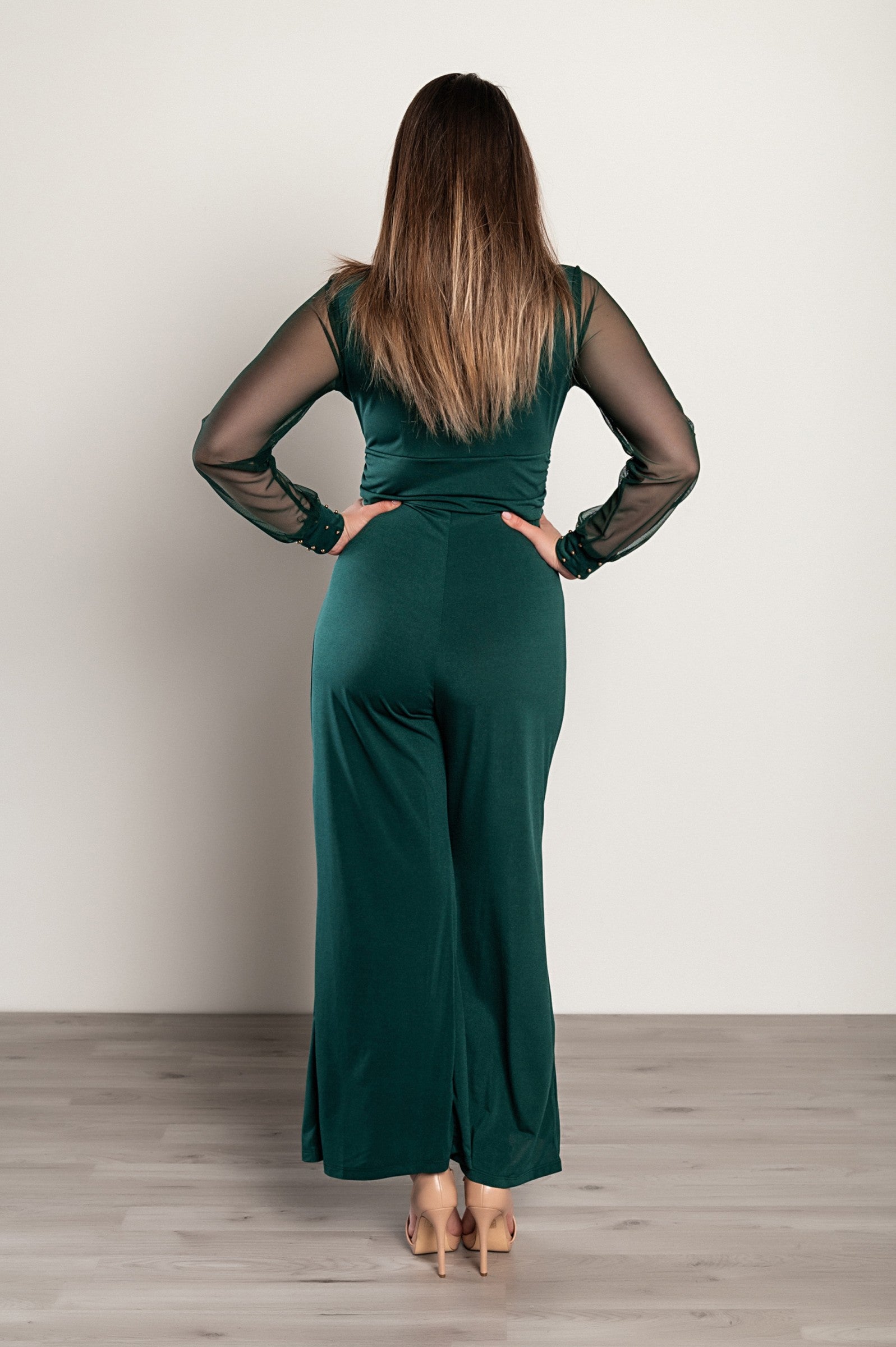 Elegant V-Neck Jumpsuit Georgina in Dark Green featuring long transparent sleeves and gold rivets, perfect for formal events.