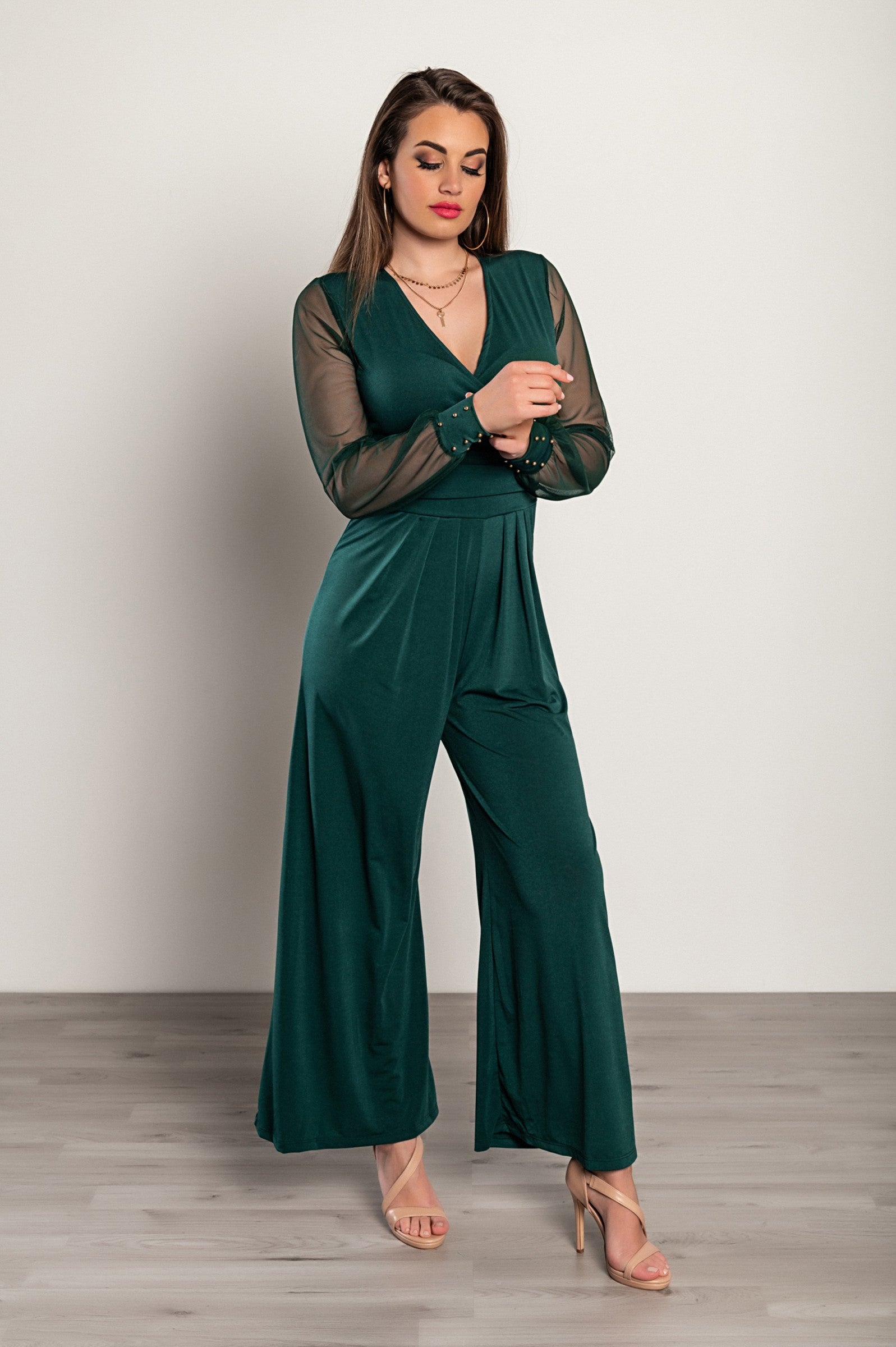 Elegant V-Neck Jumpsuit Georgina in Dark Green featuring long transparent sleeves and gold rivets, perfect for formal events.