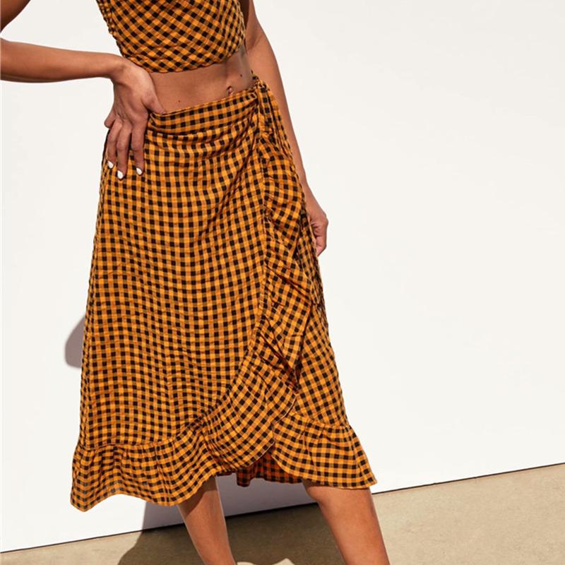 Elegant yellow plaid ruffle midi skirt featuring a high waist and bow detail, perfect for women's fashion.