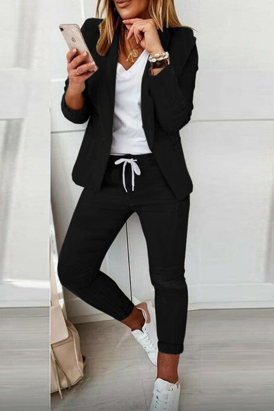 Elegant black trouser suit featuring a stylish blazer and fitted pants, made in Italy.