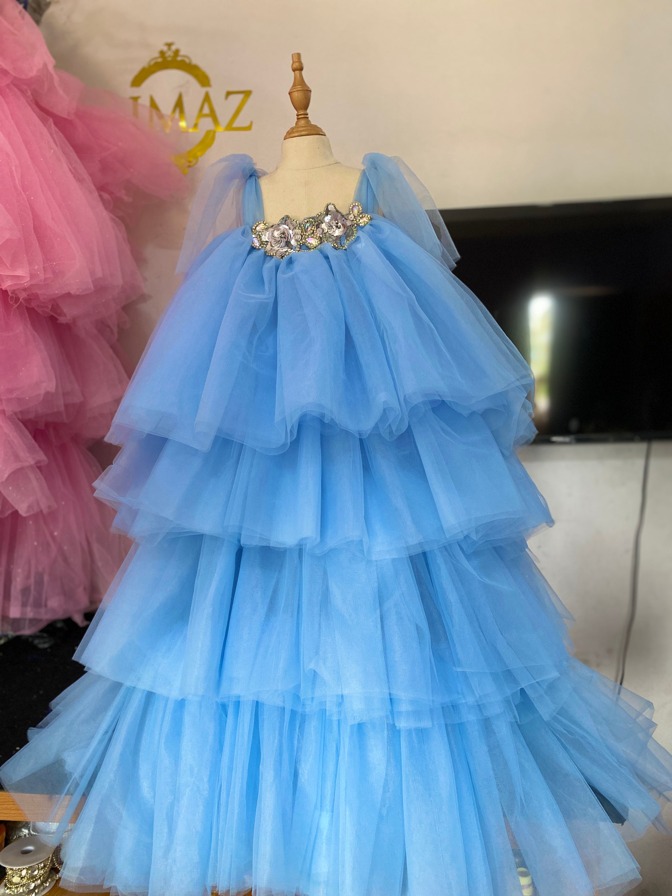 A beautiful little girl's tulle dress in soft pastel colors, featuring layers of tulle and a comfortable fit, perfect for special occasions.