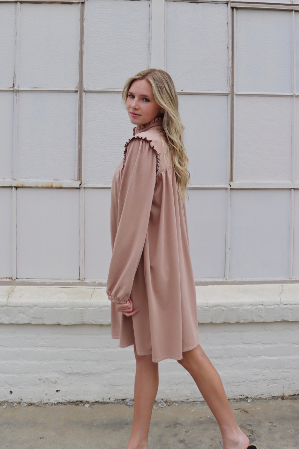 A stylish knee-length Embrace Dress featuring intricate neckline and shoulder details, made from 100% organic cotton in olive and rose pink colors.