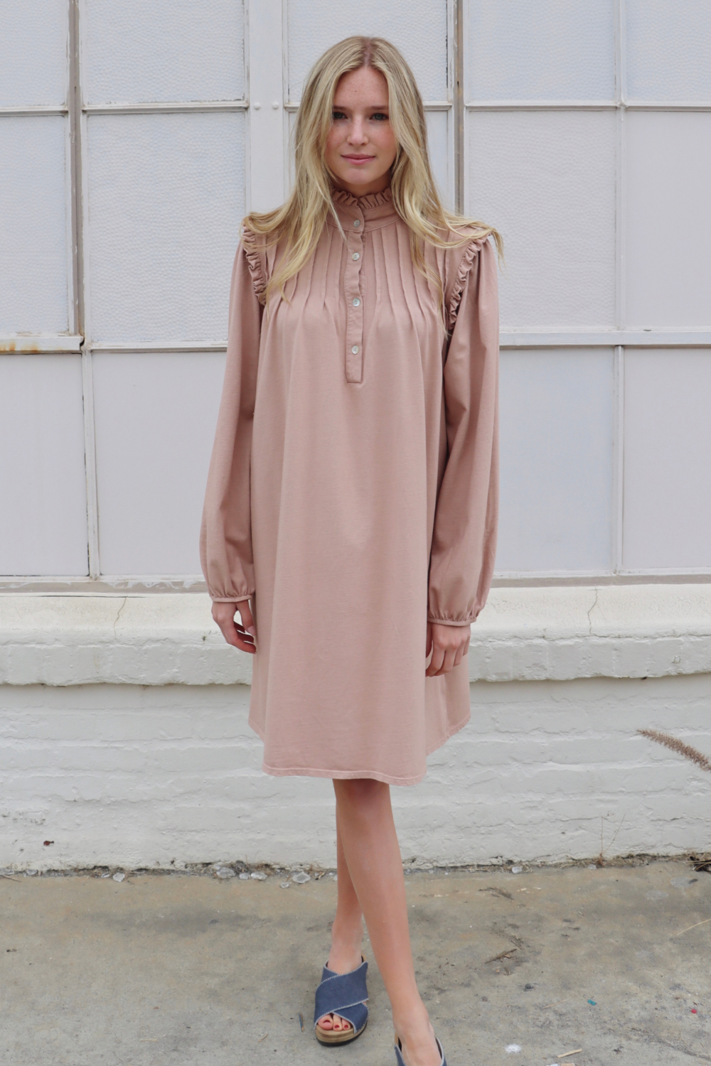 A stylish knee-length Embrace Dress featuring intricate neckline and shoulder details, made from 100% organic cotton in olive and rose pink colors.