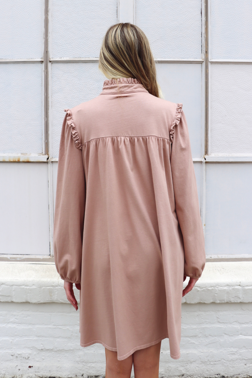 A stylish knee-length Embrace Dress featuring intricate neckline and shoulder details, made from 100% organic cotton in olive and rose pink colors.