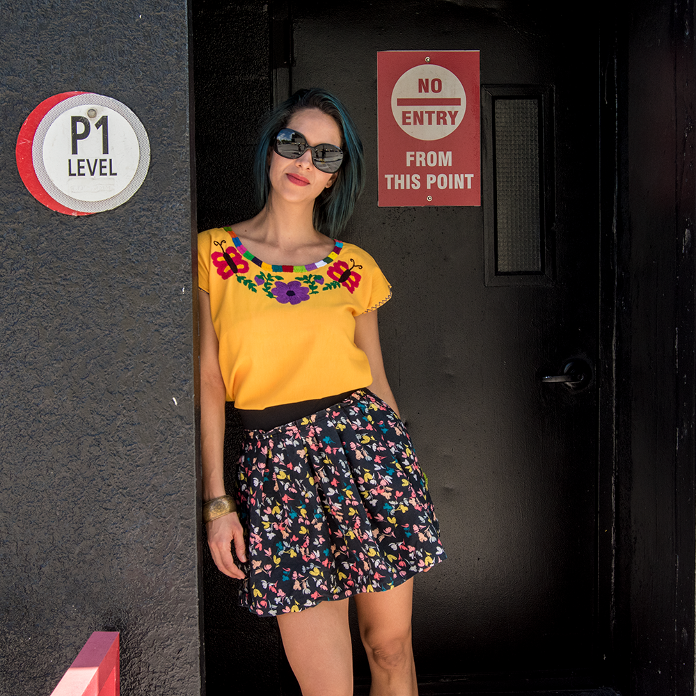 Embroidered blouse featuring colorful floral designs, handcrafted by Mexican artisans from Oaxaca, made of soft cotton fabric.