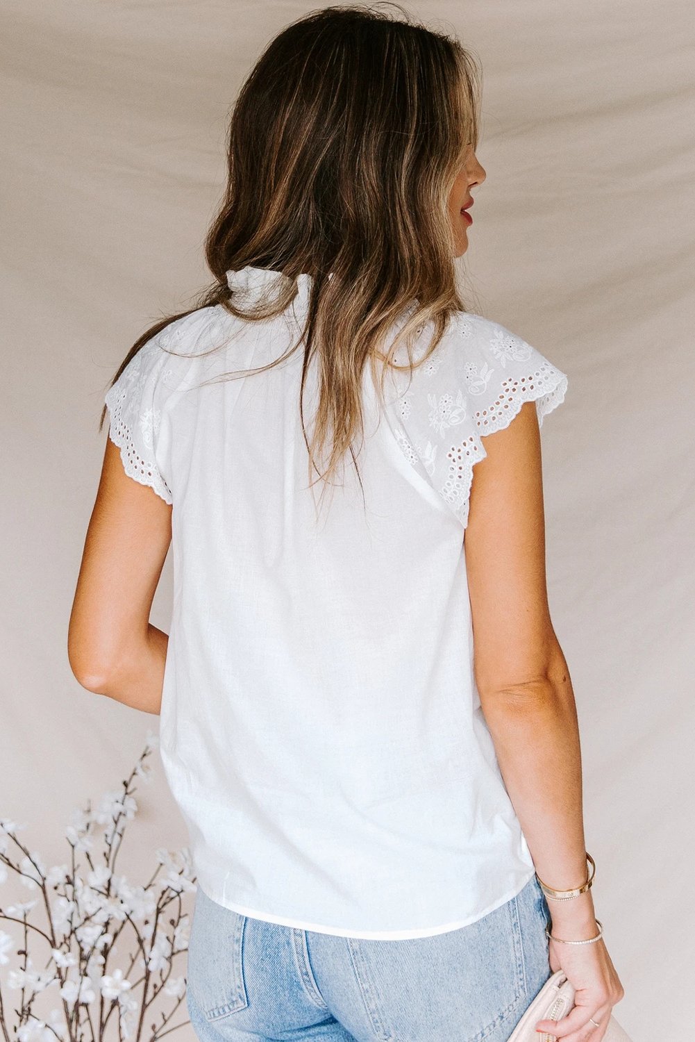 Embroidered Eyelet Cap Sleeves Top featuring scalloped sleeves and a smocked neckline, perfect for summer wear.