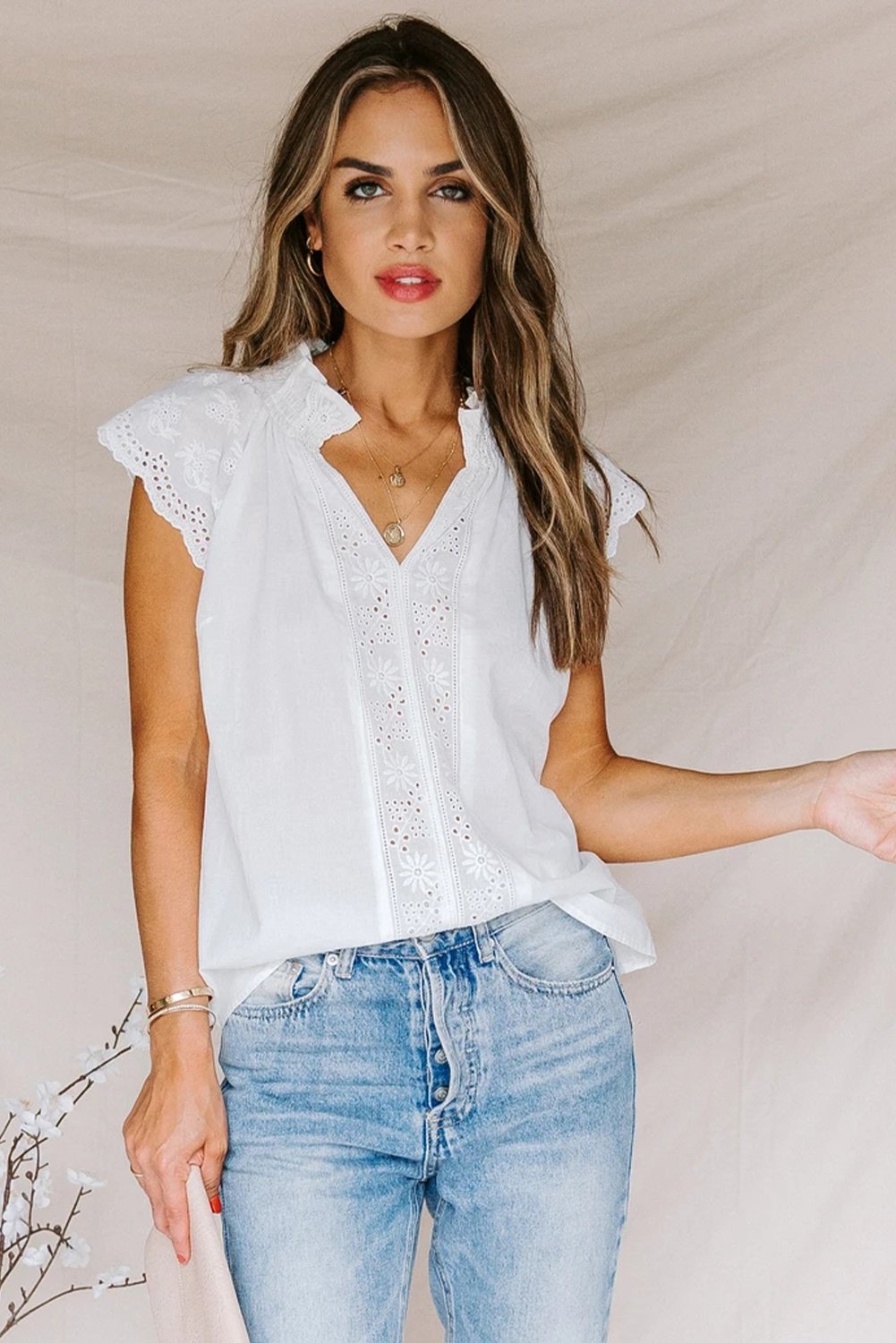 Embroidered Eyelet Cap Sleeves Top featuring scalloped sleeves and a smocked neckline, perfect for summer wear.