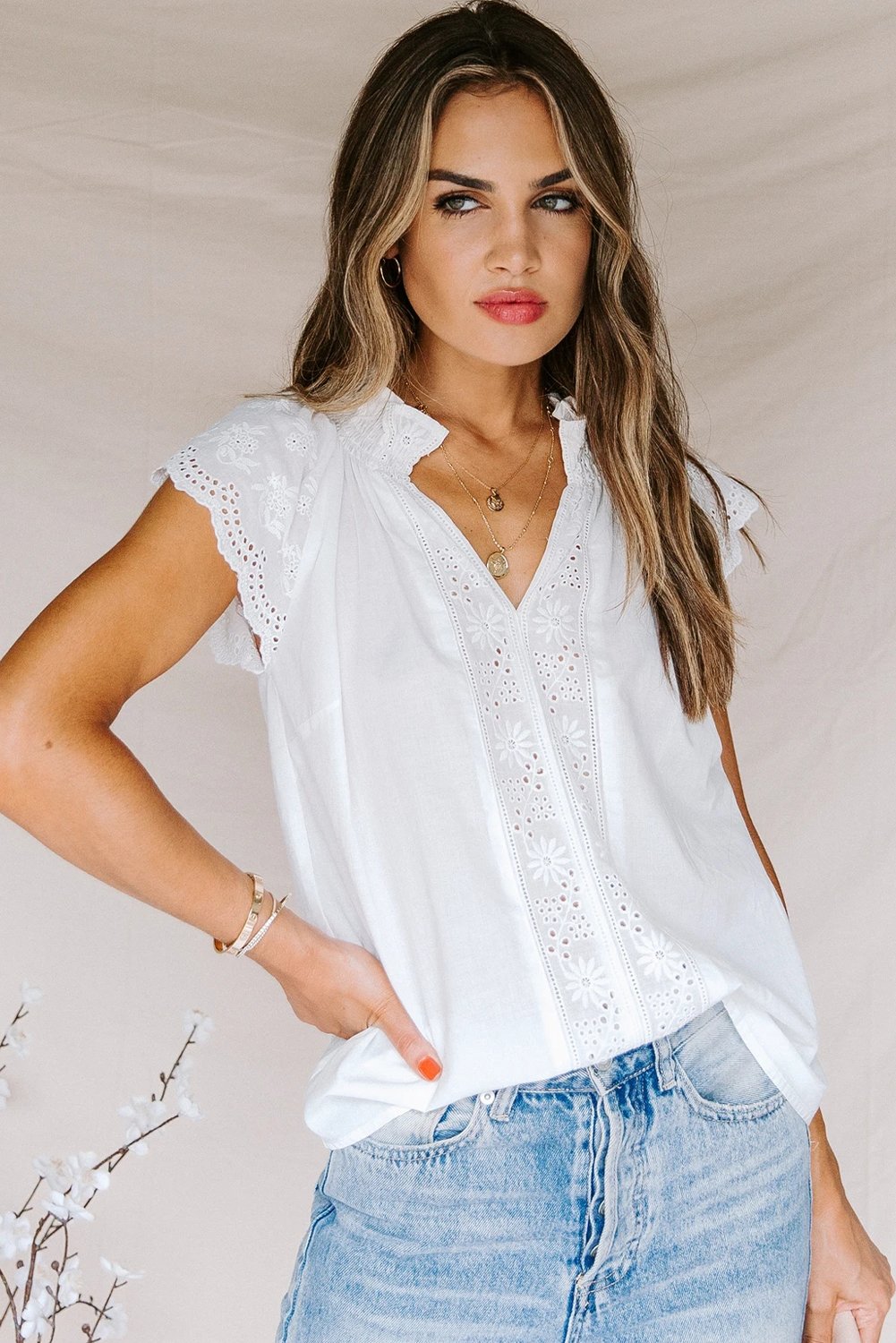 Embroidered Eyelet Cap Sleeves Top featuring scalloped sleeves and a smocked neckline, perfect for summer wear.