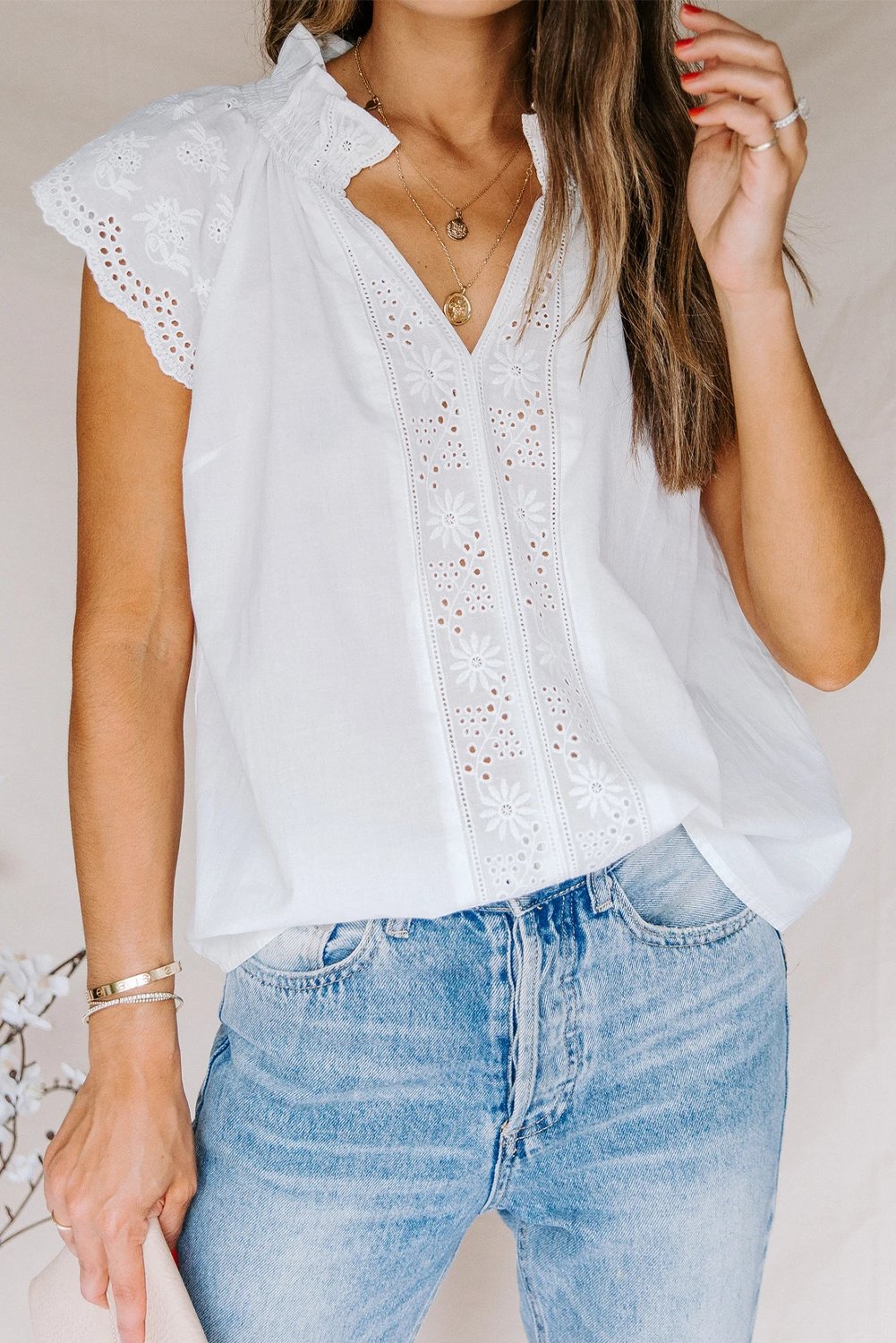 Embroidered Eyelet Cap Sleeves Top featuring scalloped sleeves and a smocked neckline, perfect for summer wear.