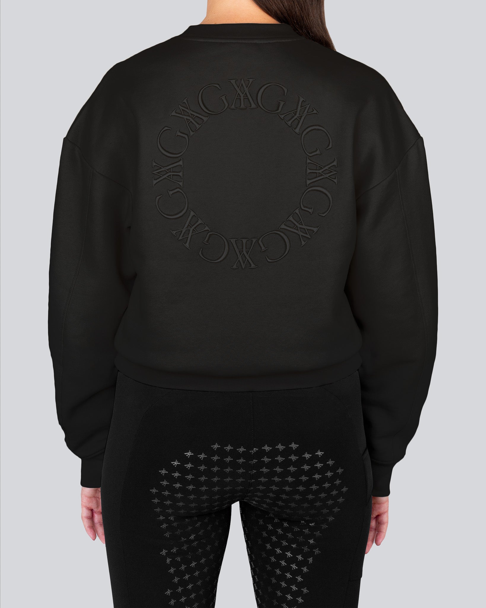 Black embroidered sweatshirt made from 100% organic cotton, featuring tonal embroidery and voluminous long sleeves.