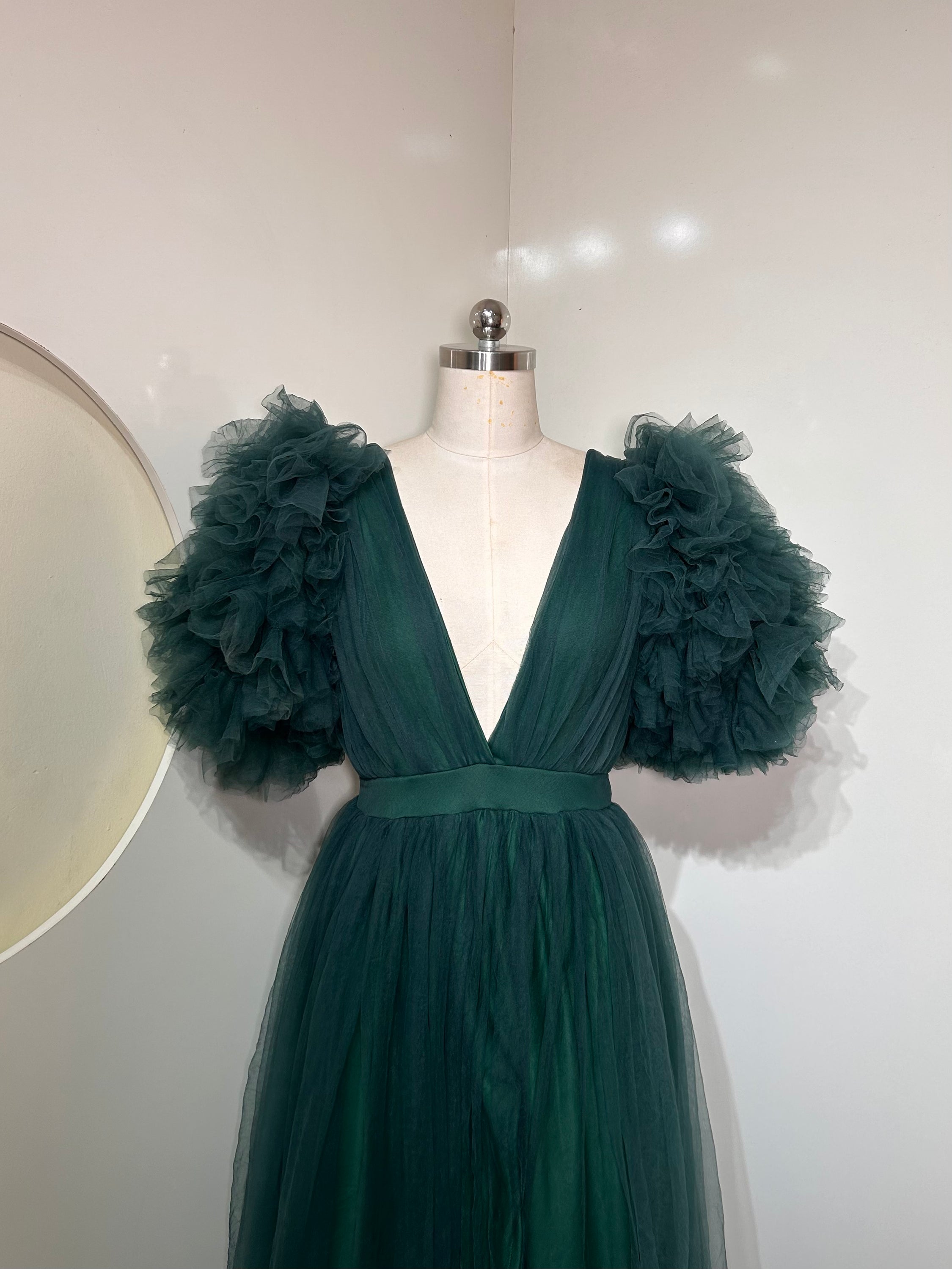 Emerald Green Ixora Dress featuring a plunging V-neckline and thigh-high slit, crafted from luxurious shimmering fabric.