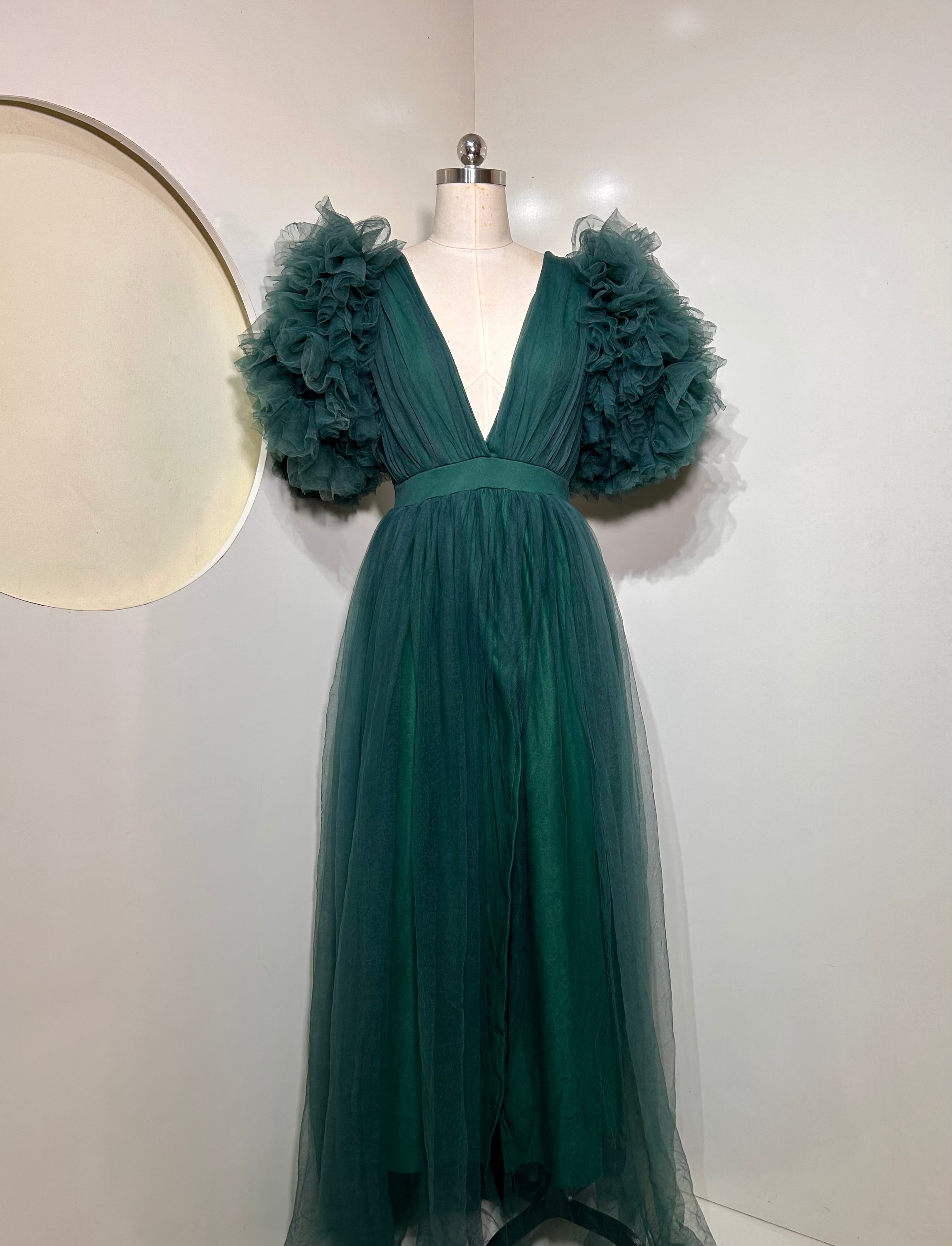 Emerald Green Ixora Dress featuring a plunging V-neckline and thigh-high slit, crafted from luxurious shimmering fabric.