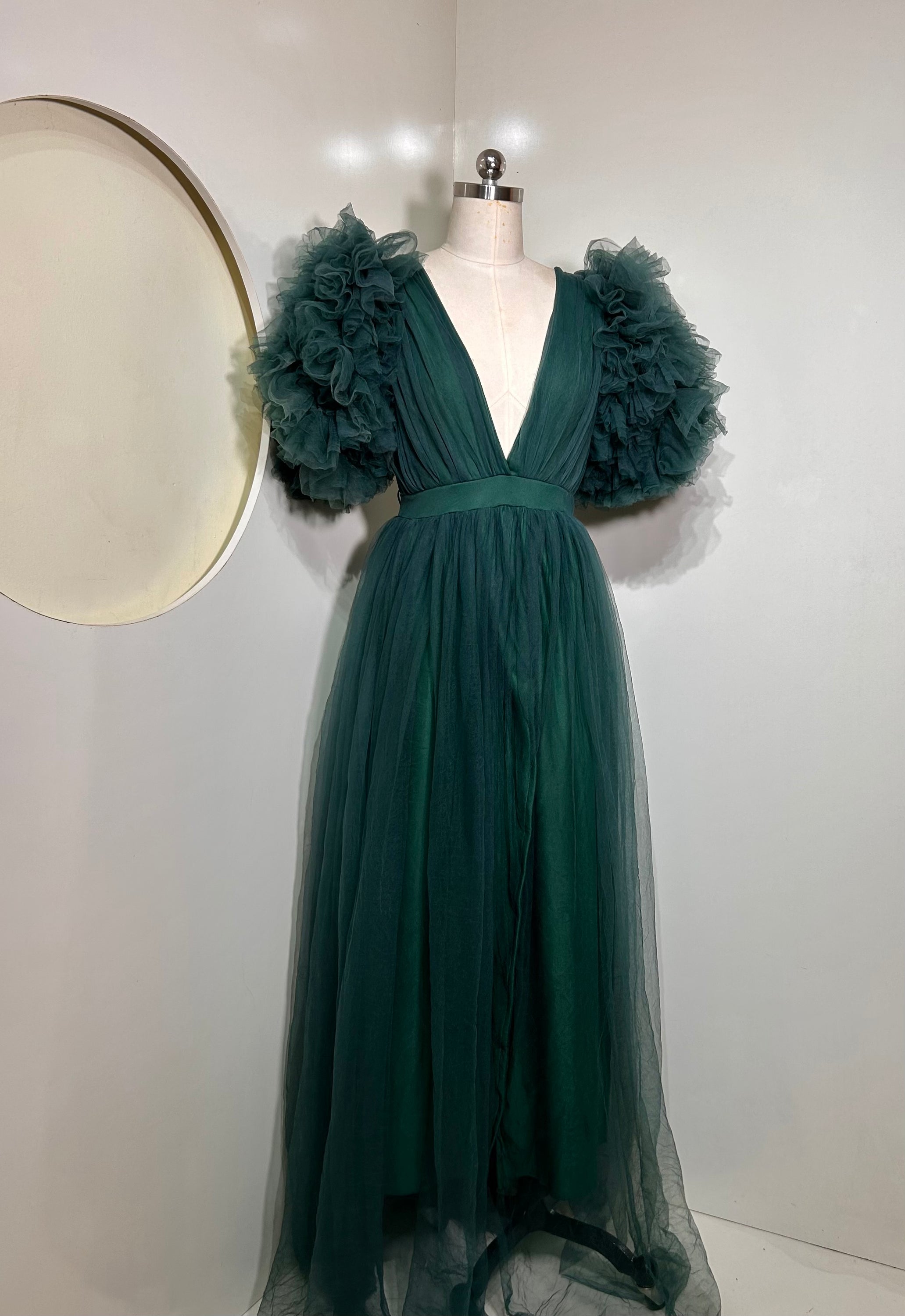 Emerald Green Ixora Dress featuring a plunging V-neckline and thigh-high slit, crafted from luxurious shimmering fabric.