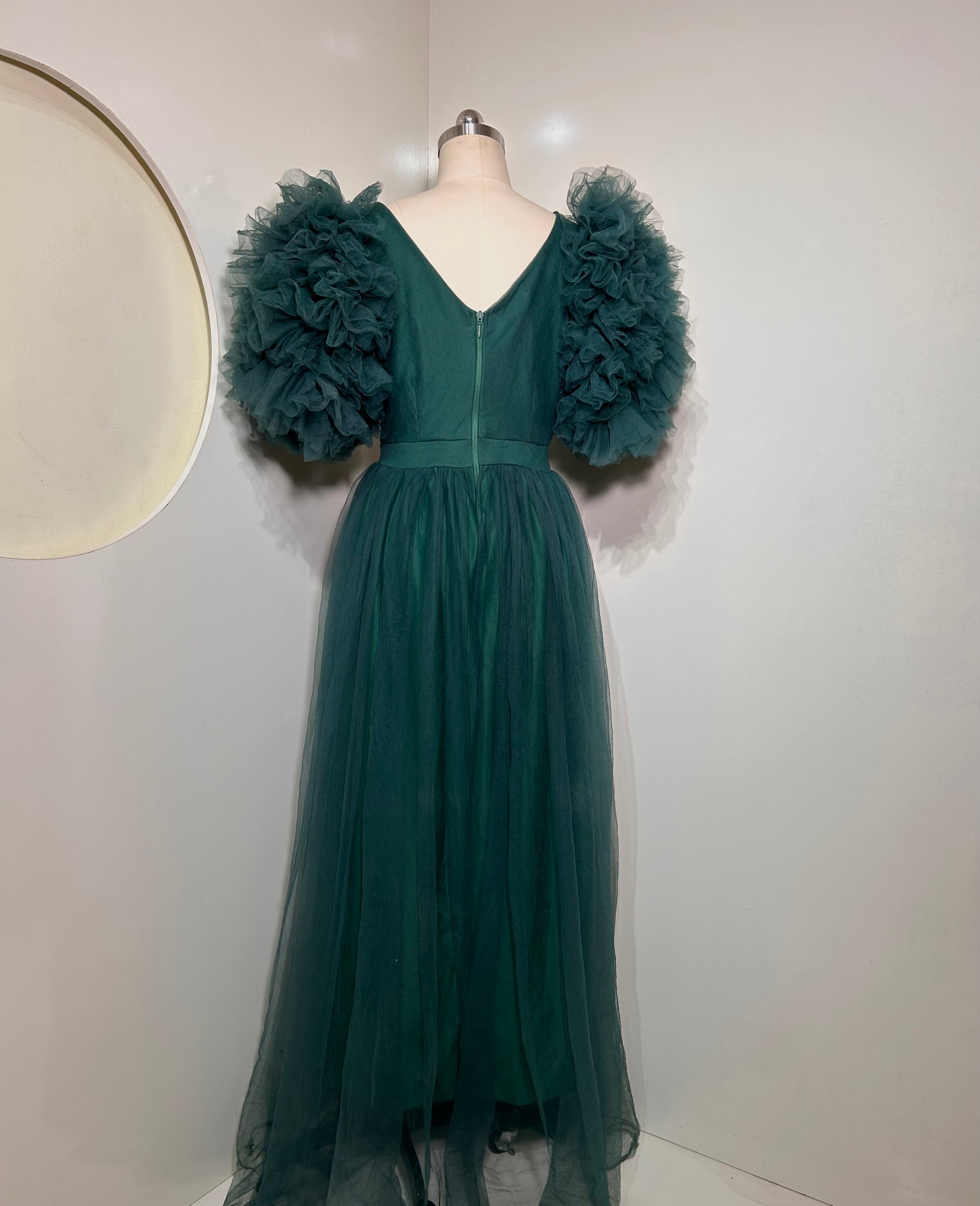 Emerald Green Ixora Dress featuring a plunging V-neckline and thigh-high slit, crafted from luxurious shimmering fabric.