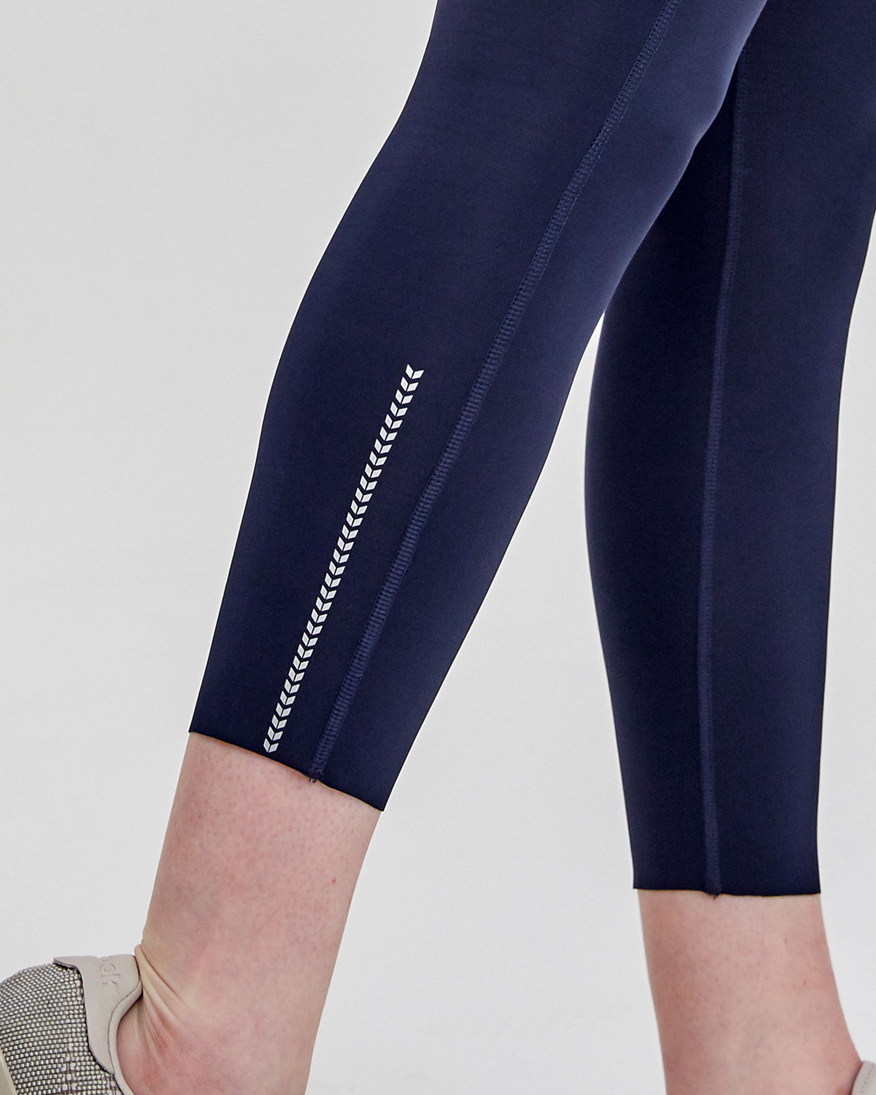 Energy Reflective Silkiflex™ Legging showcasing chevron reflective graphics and laser cut leg openings, perfect for activewear.