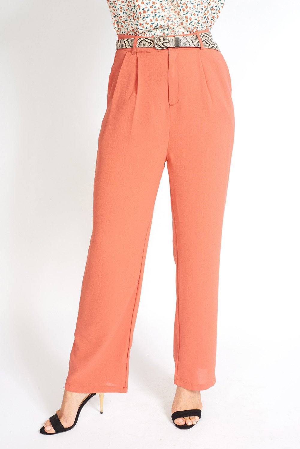 Essential High Waisted Suit Pants in a stylish setting, showcasing pleated detailing and side pockets.