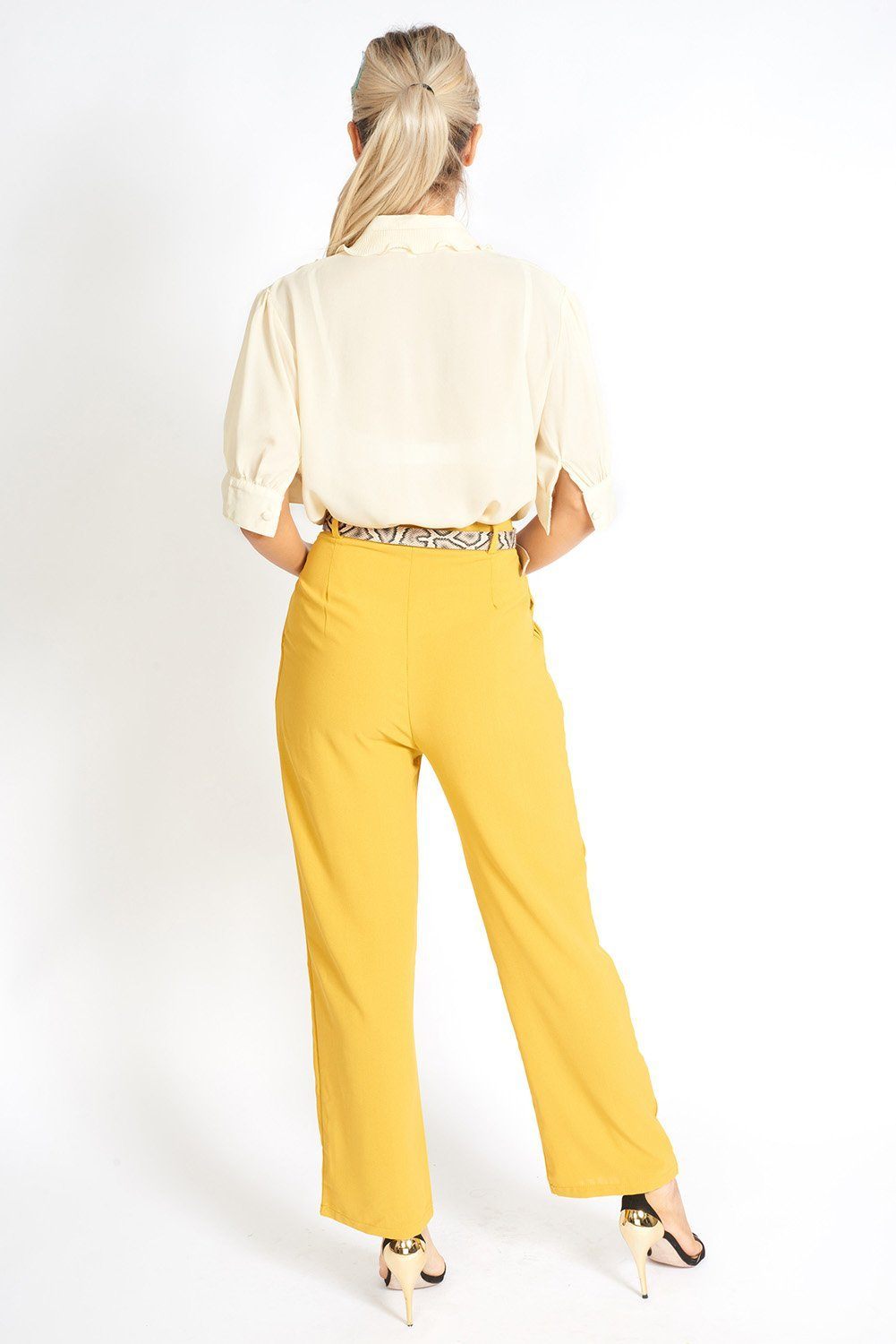 Essential High Waisted Suit Pants in a stylish setting, showcasing pleated detailing and side pockets.