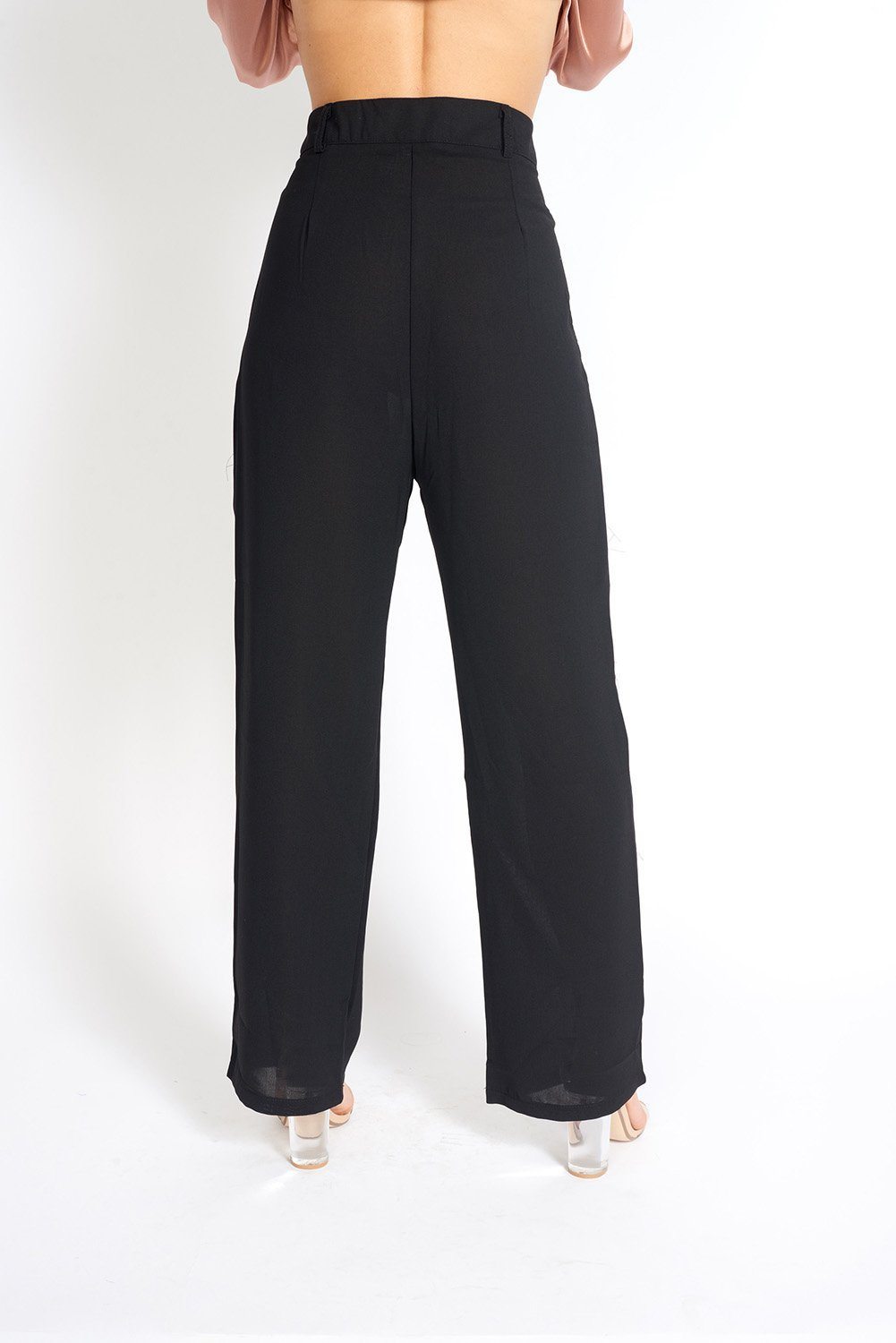 Essential High Waisted Suit Pants in a stylish setting, showcasing pleated detailing and side pockets.