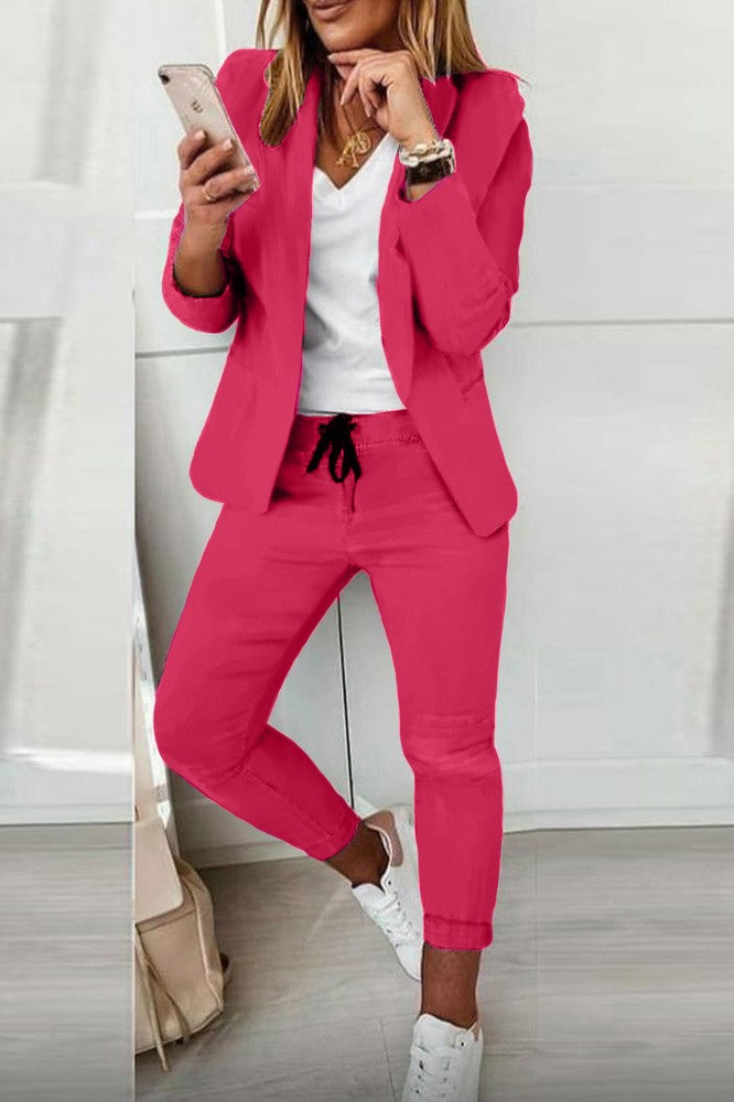 Elegant fuchsia blazer pants set featuring a classic collar and long sleeves, made from soft fabric with fitted trousers.