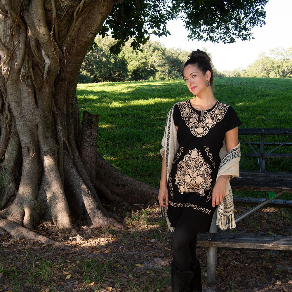 A beautiful Ethnic Folk Golden Embroidered Mexican Dress featuring intricate golden floral embroidery, showcasing its unique artisan craftsmanship.