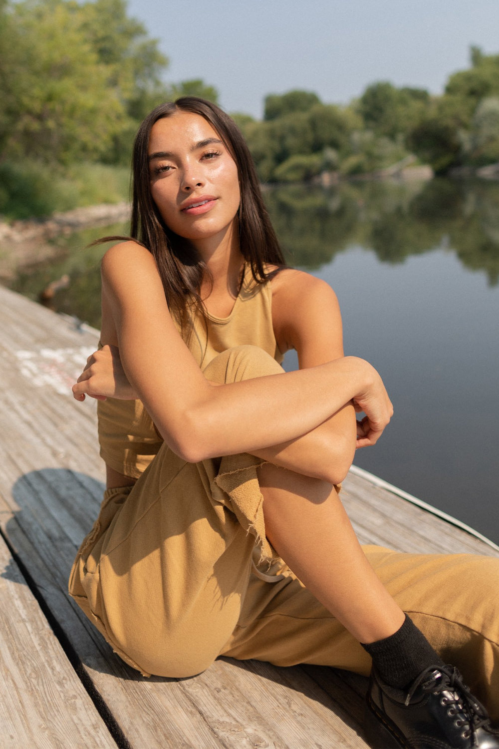 A pair of slouchy, cropped Everyday Pants in washed black with a drawstring waist and pockets, showcasing a relaxed fit and flared raw cut hem.