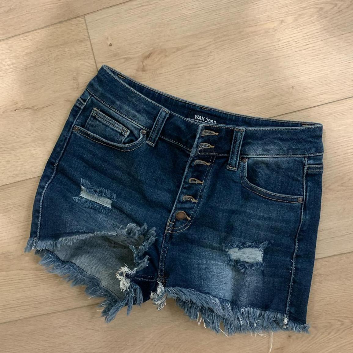 A pair of stylish Exposed Button Frayed Hem Shorts featuring a distressed design and button fly, perfect for summer wear.